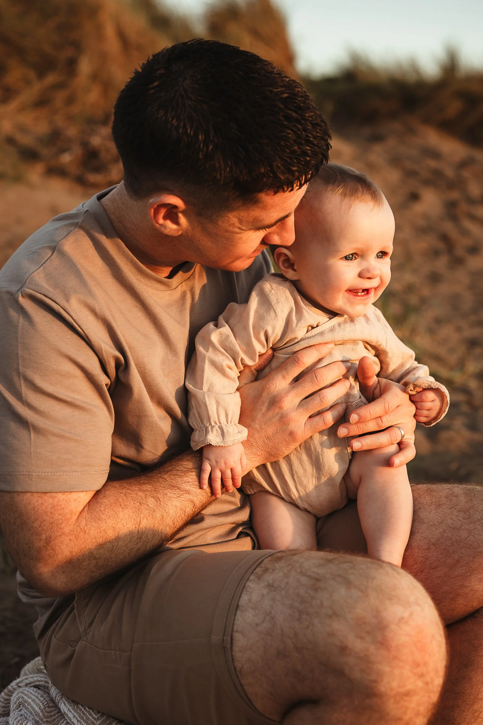 A father and baby sharing a quiet golden hour moment together, capturing the love and connection between them.