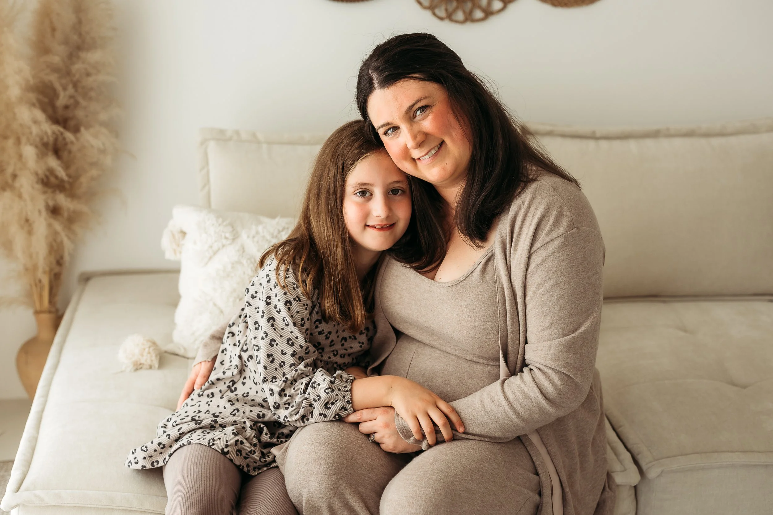 A mother and daughter sharing a cosy moment together at home, capturing their close bond and the everyday connection between them.