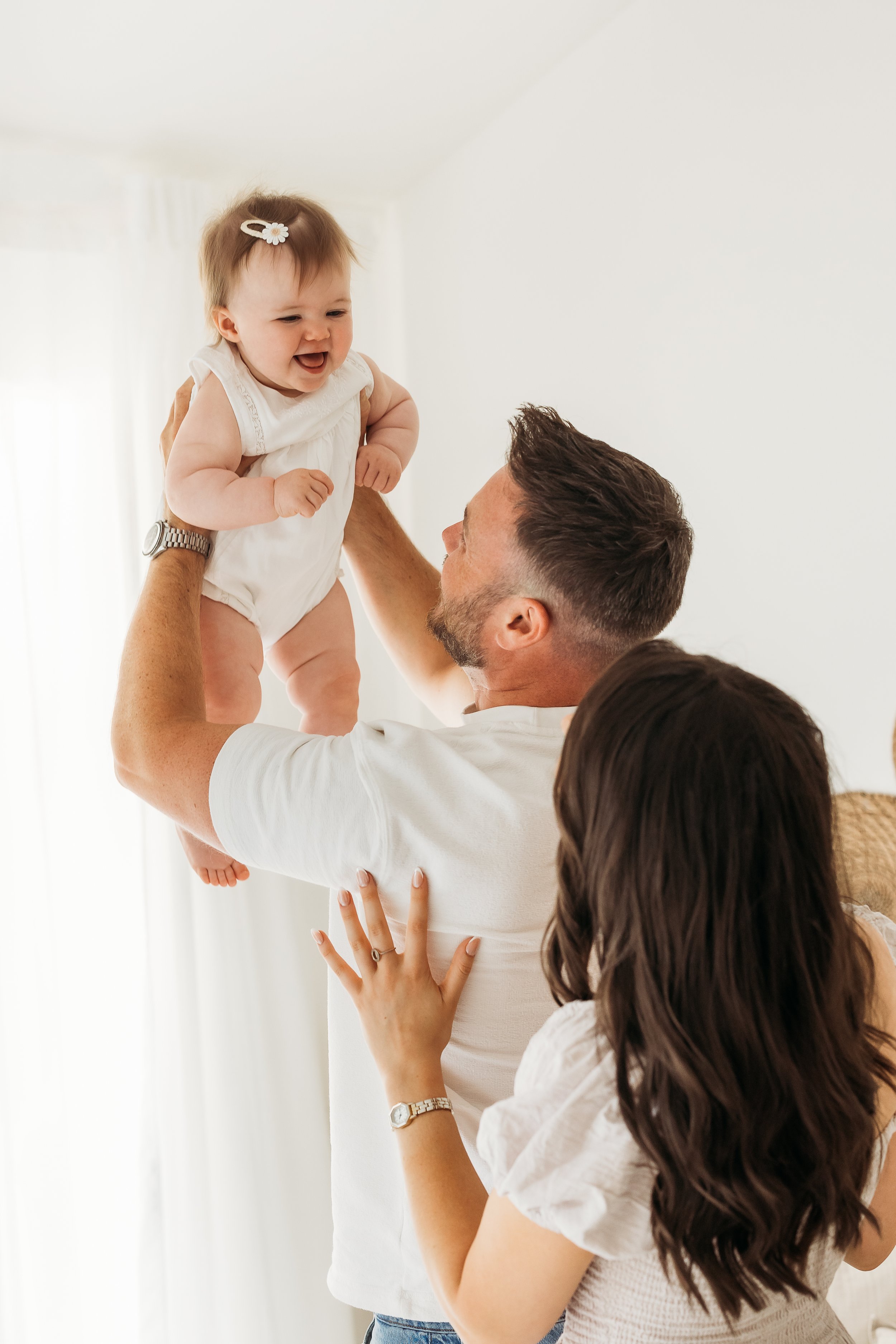 A joyful family moment celebrating one year of love, laughter and the bond between parents and their little one.