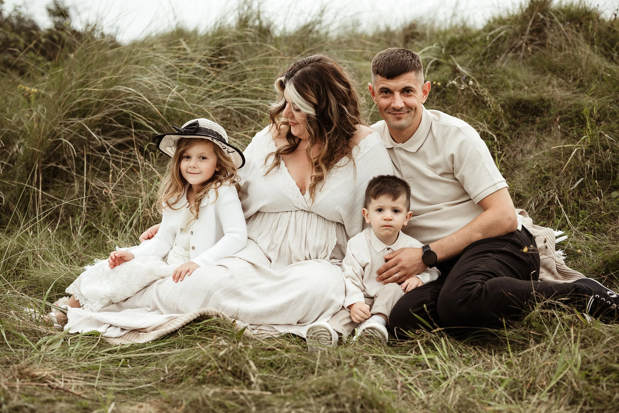 A family of five sharing a relaxed outdoor moment surrounded by nature, preserving the love, connection and personalities that make their family unique.