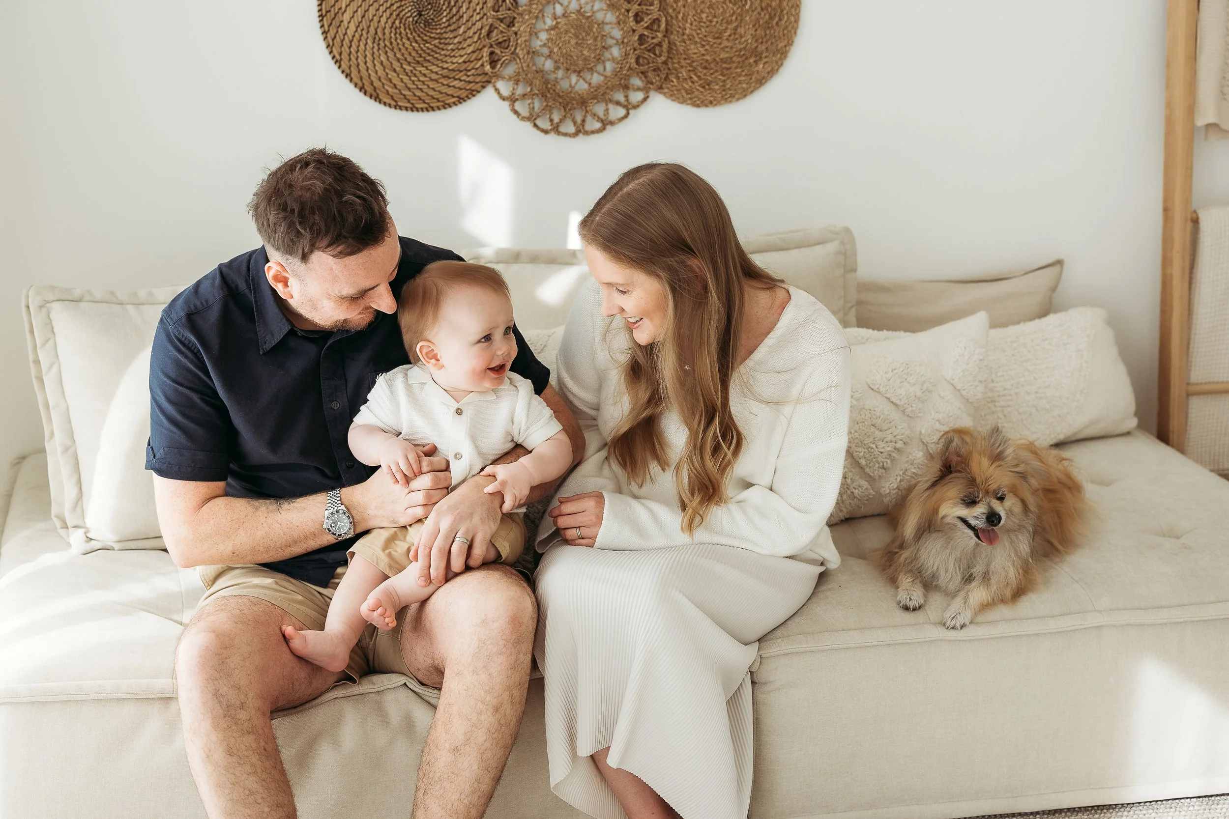 A family celebrating this special season together, surrounded by love, connection and the furry members of their family.