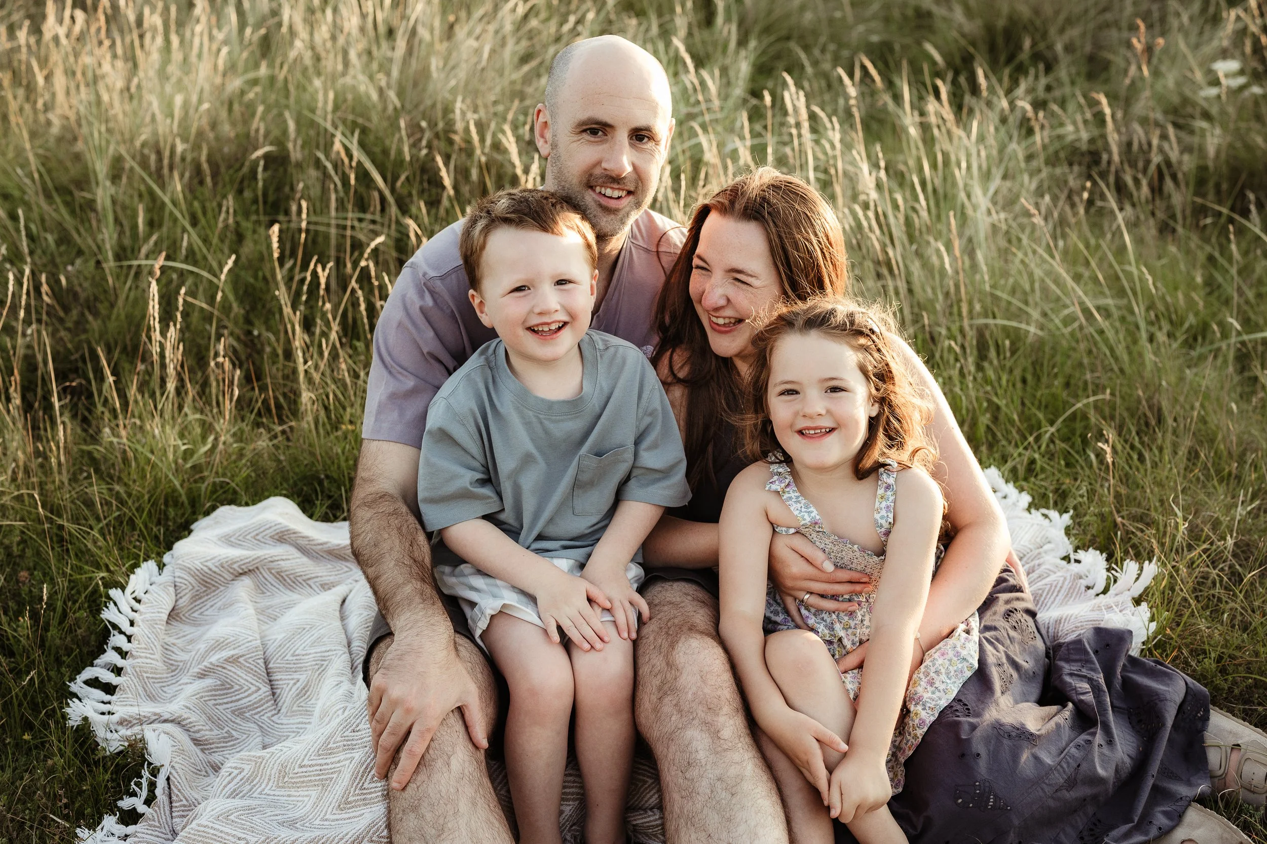 A family enjoying time together outdoors, capturing laughter, connection and the beautiful chaos of family life.