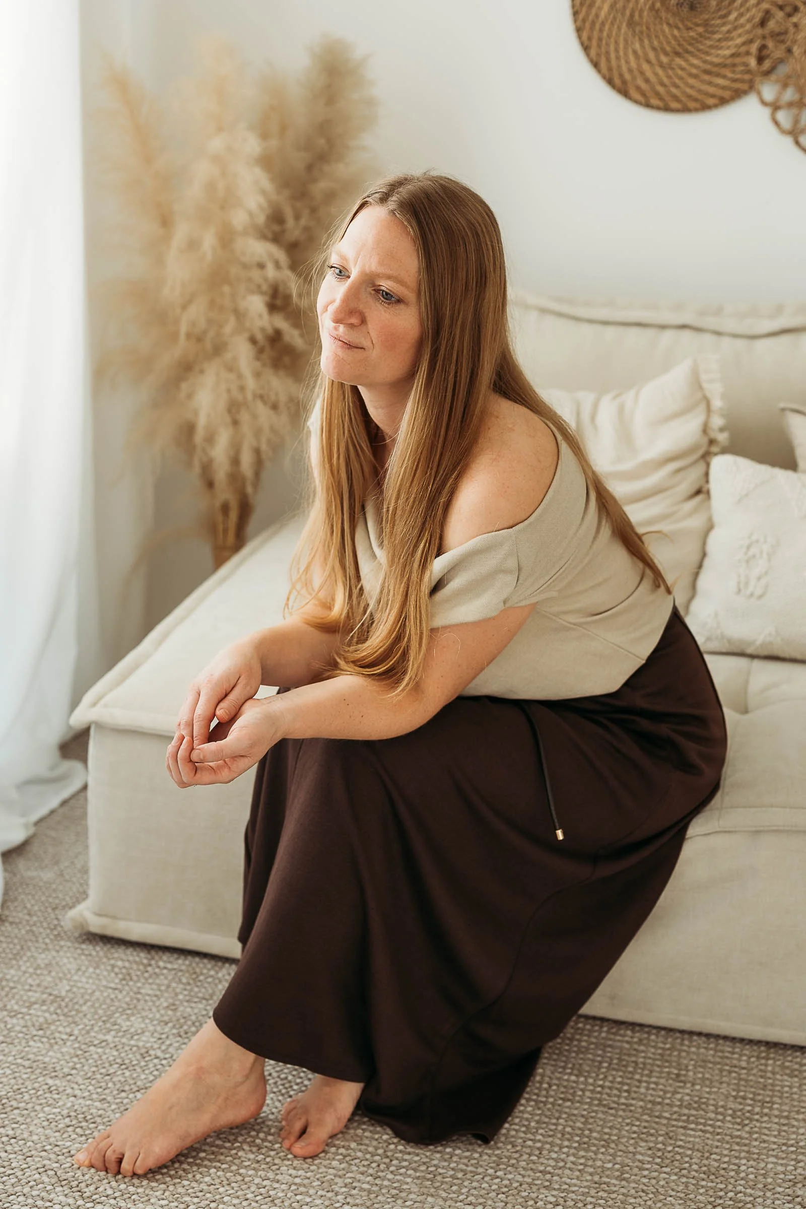 Ines Henderson, family and newborn photographer, sitting in her natural light studio in Cumbria.