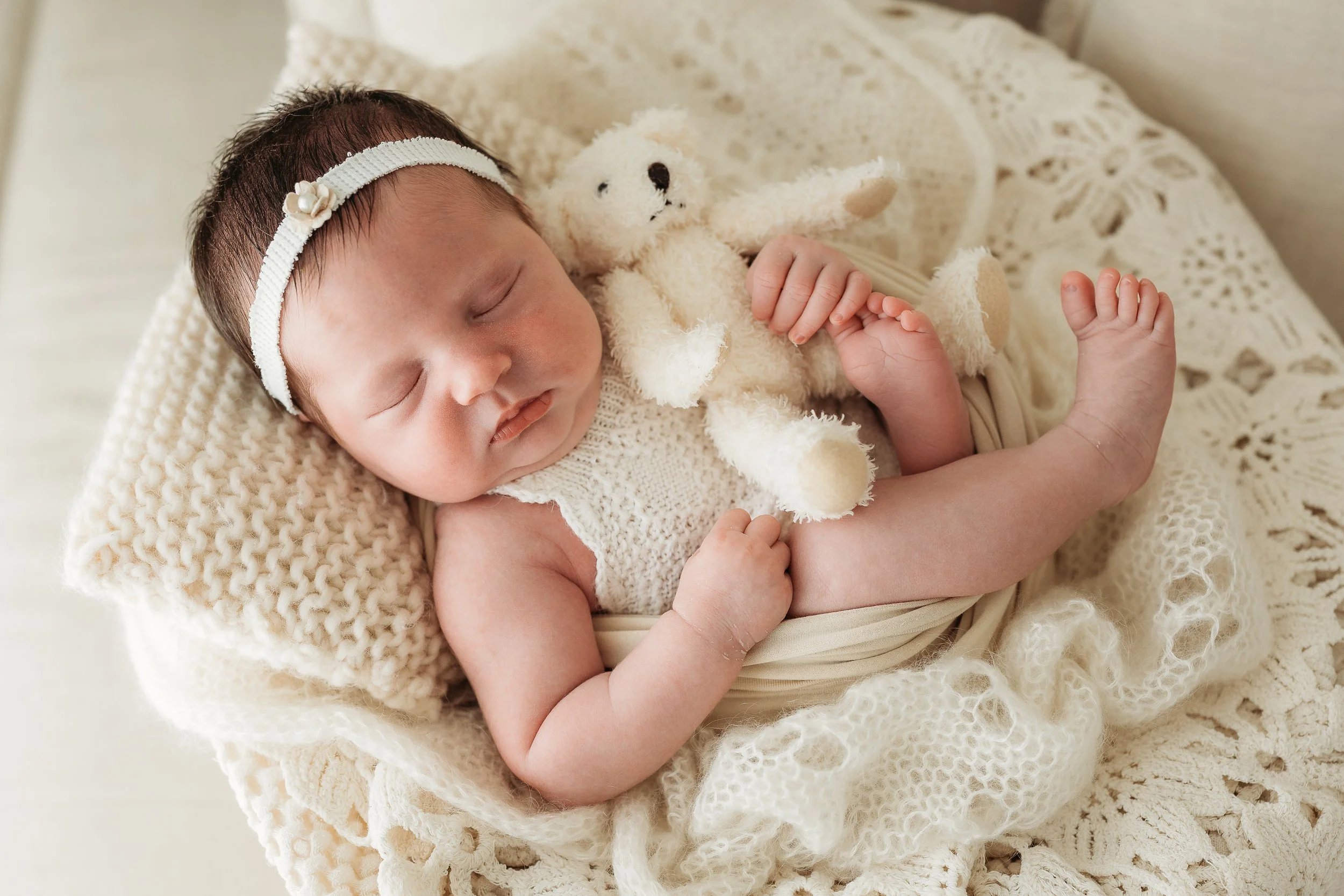 Sleeping newborn baby photographed during a gentle, natural newborn photography session.