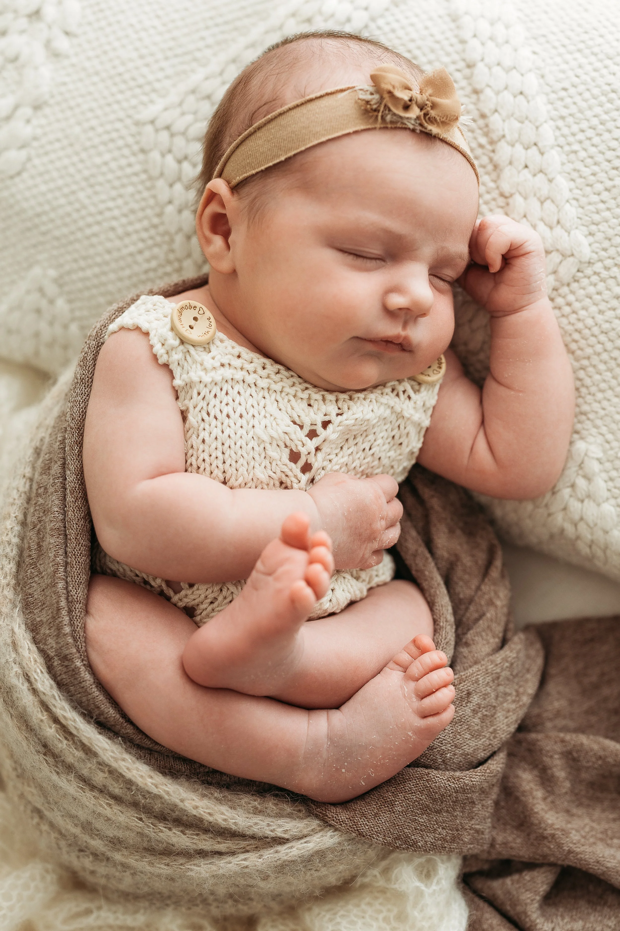 Sleeping newborn baby photographed during a natural newborn photography session.