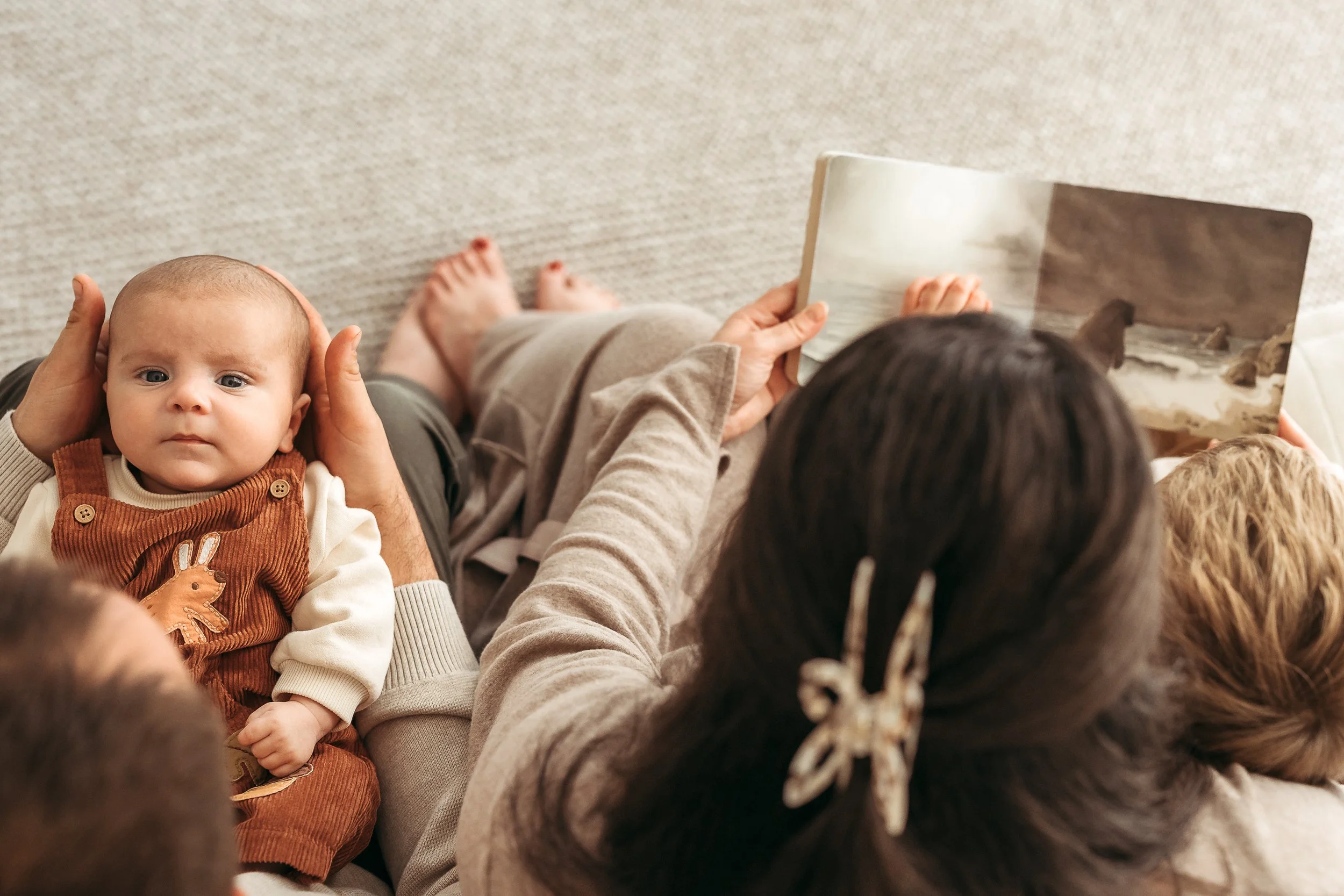 A sweet baby moment surrounded by love and connection, capturing the tiny details and interactions families treasure.