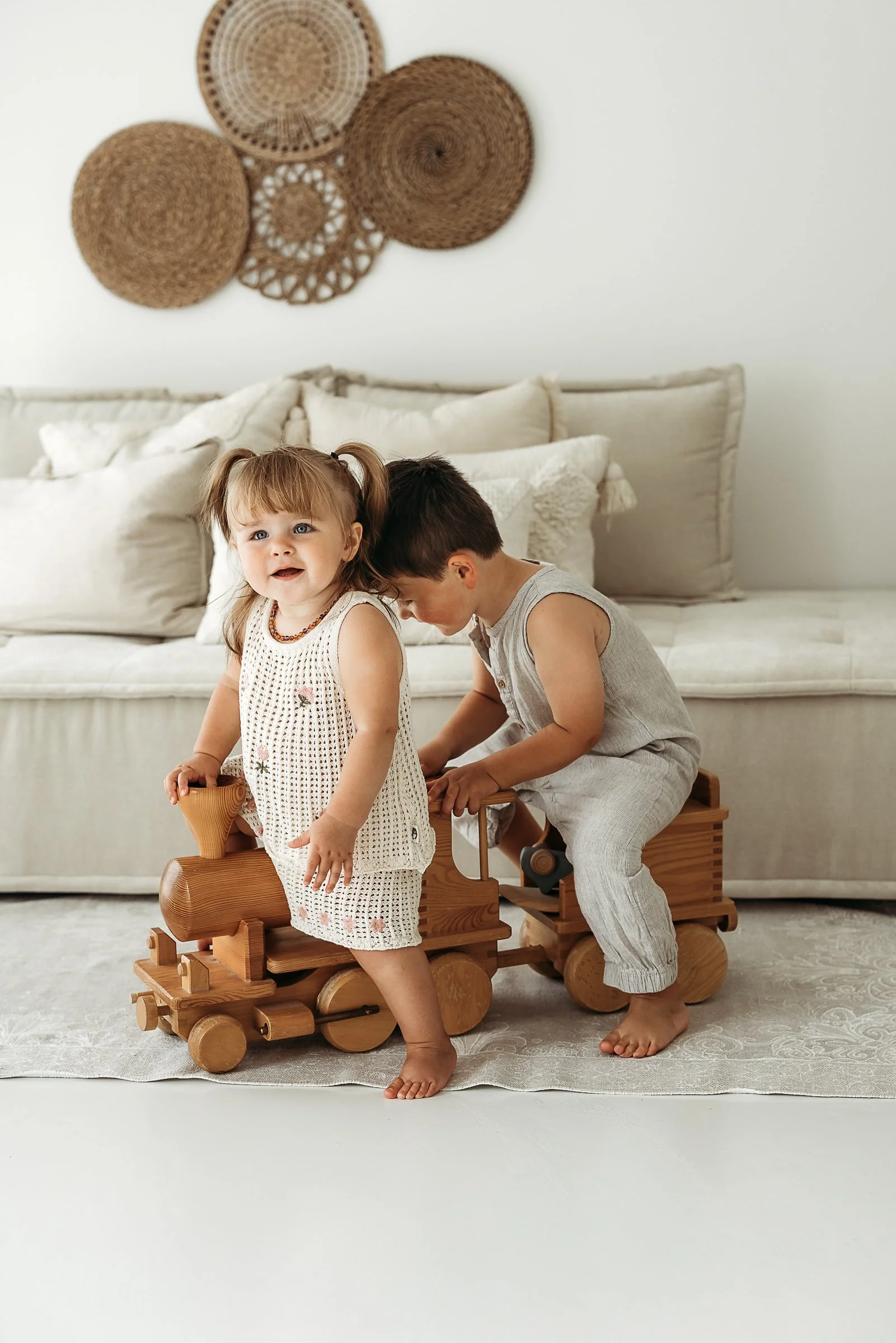Siblings enjoying a simple moment of play together, capturing their personalities, connection and the joy of childhood.