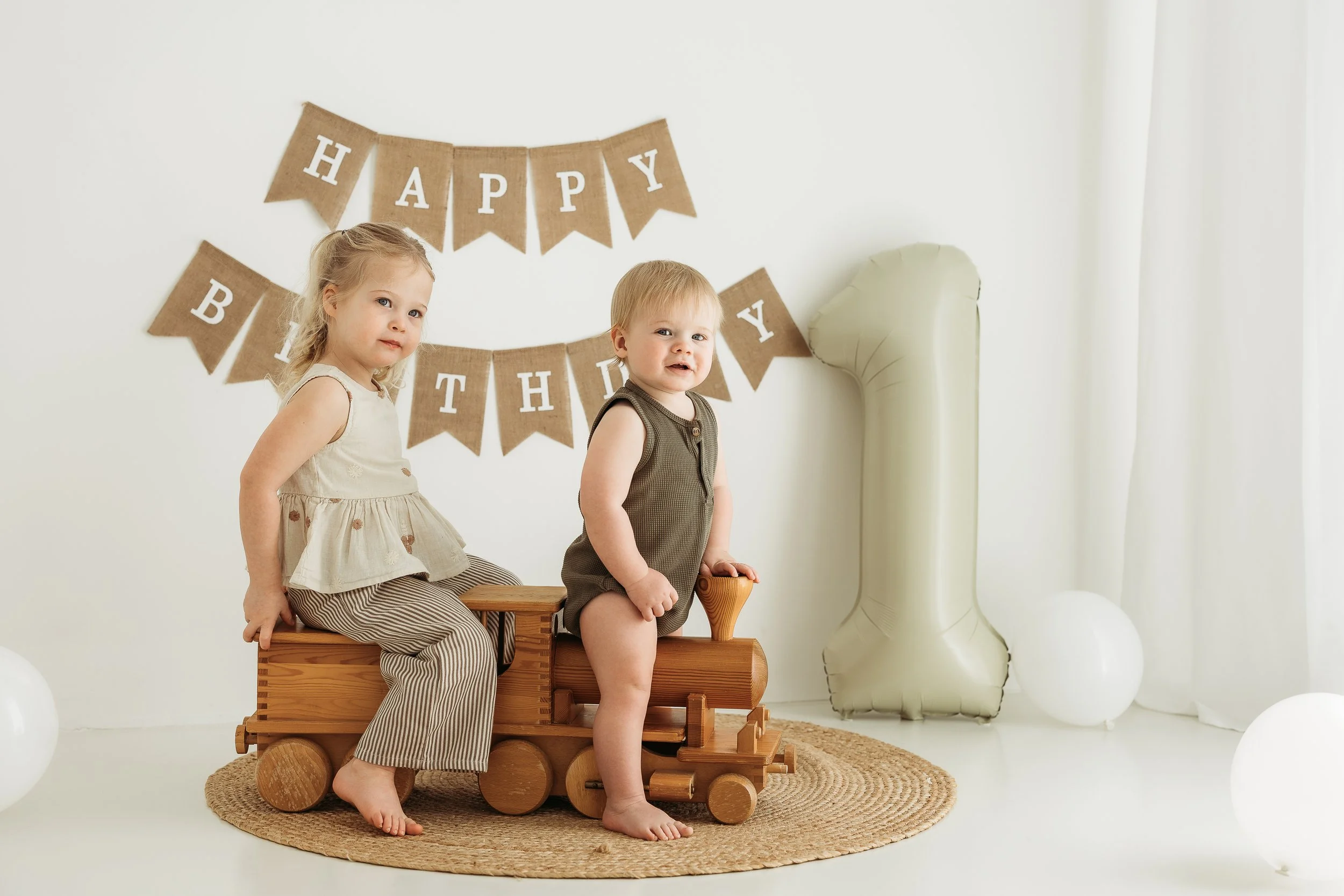 Siblings celebrating a first birthday together, capturing the excitement, laughter and little moments that make these milestones so special.