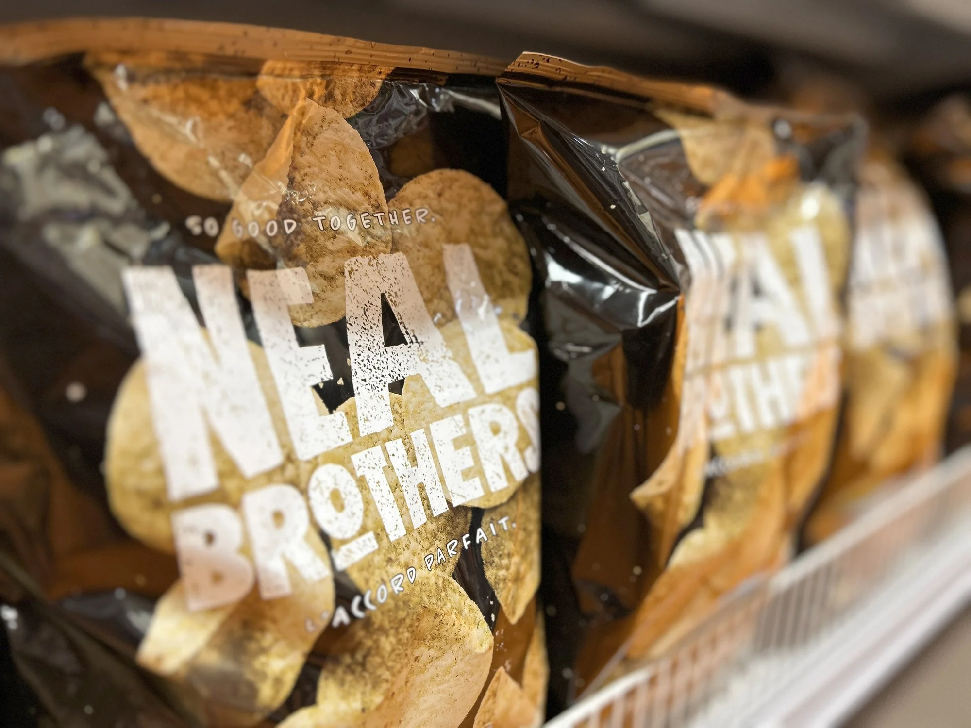 Close-up of a CPG bag with black and beige packaging, featuring a picture of tortilla chips and the words "So Good Together"