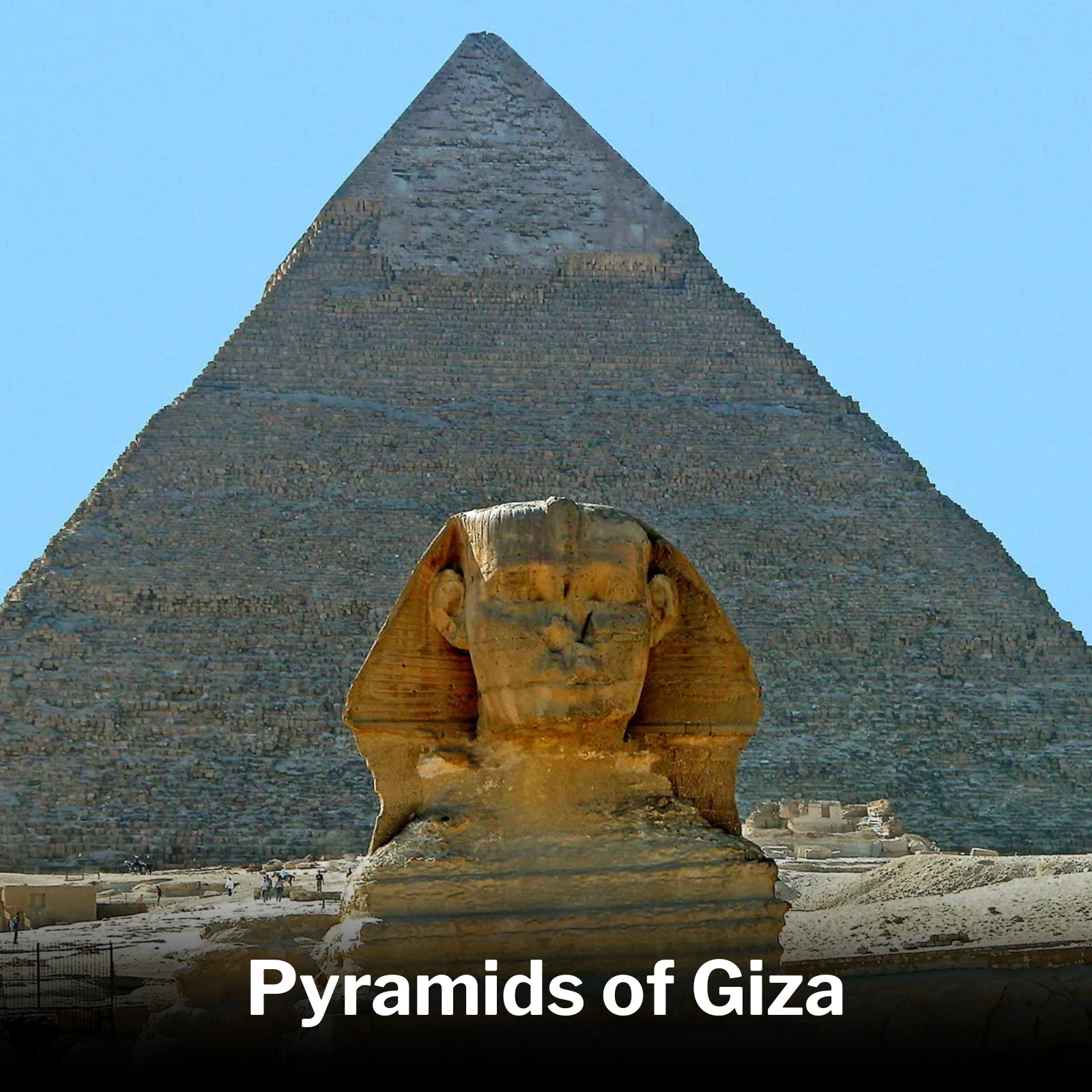 Close-up view of the Great Pyramid of Giza with a large sphinx statue in the foreground, under a clear blue sky.