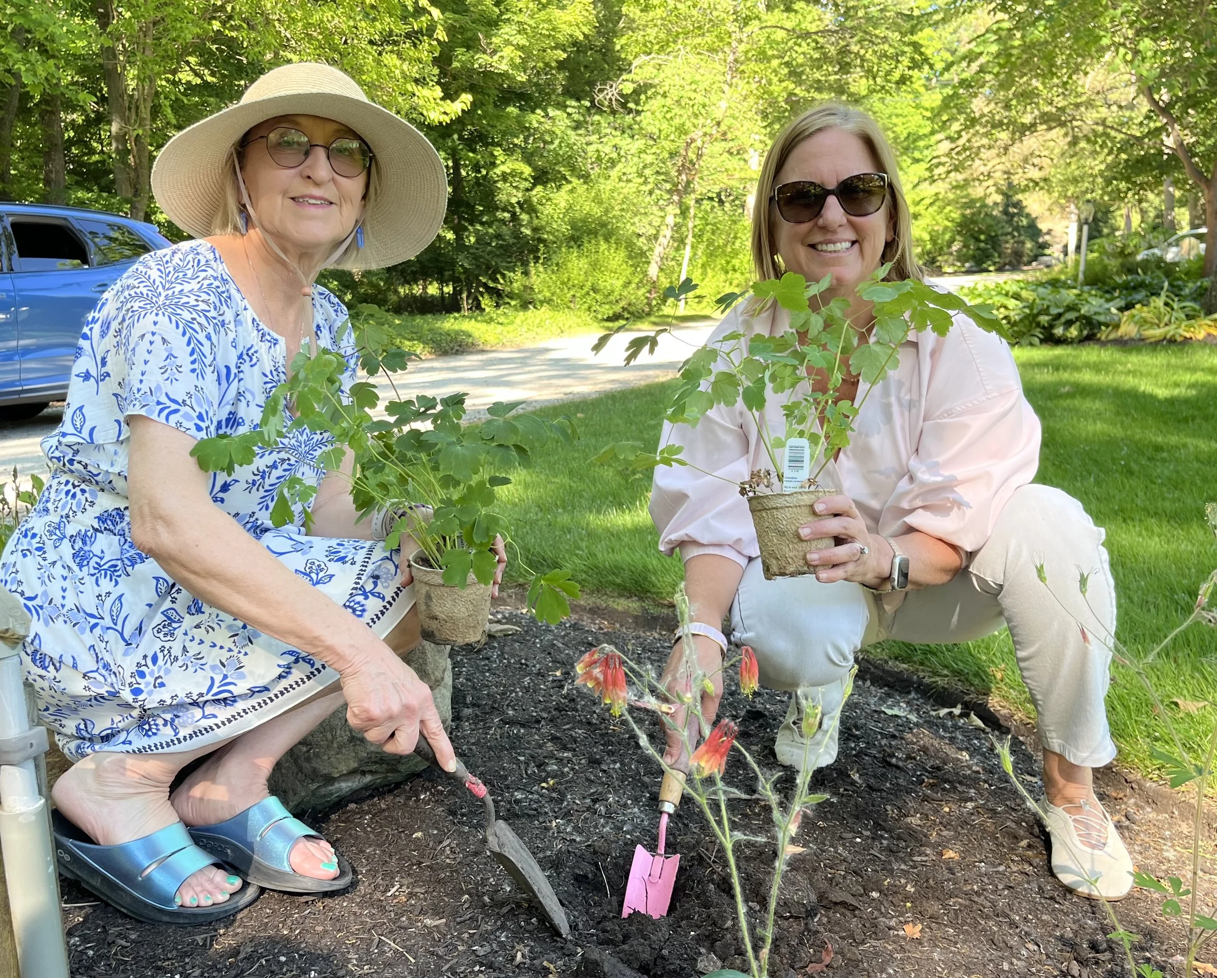 Janet & Mary plant native plants at Esquire's cottage