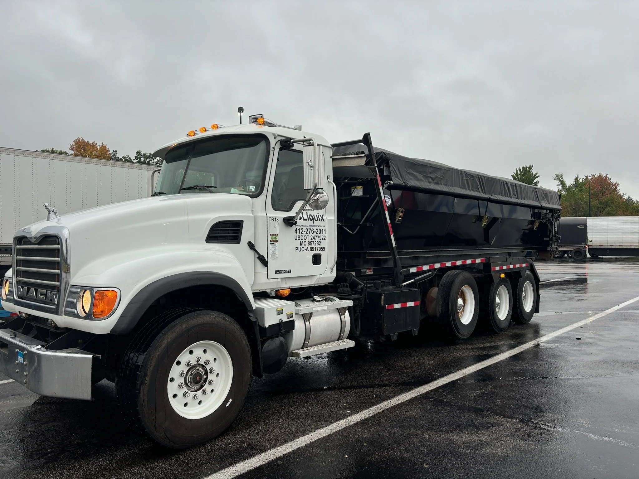 EnviroMax waste transportation roll-off truck supporting an industrial project