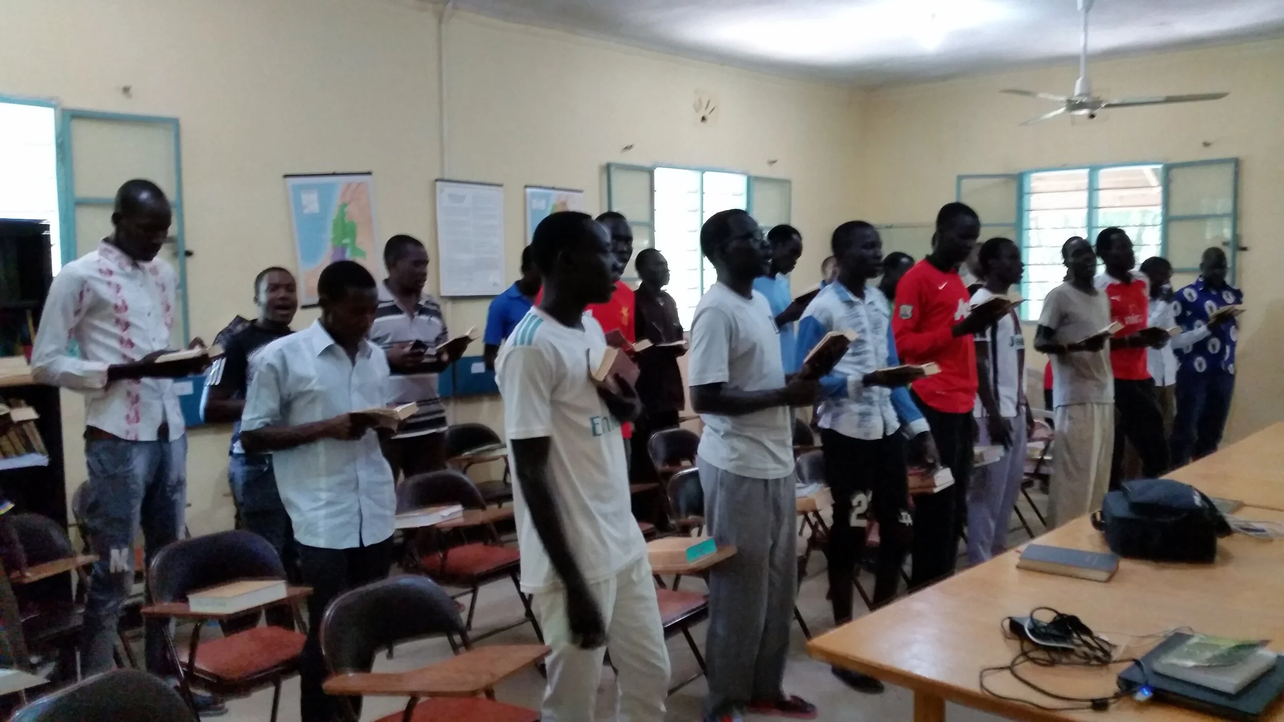 A Class of twenty-one students, a mix of Kenyan students and South Sudanese refugees from the U.N. refugee camp at Kakuma. MERF has offered in Lokichoggio three-month training in Bible and theology to over 900 students.