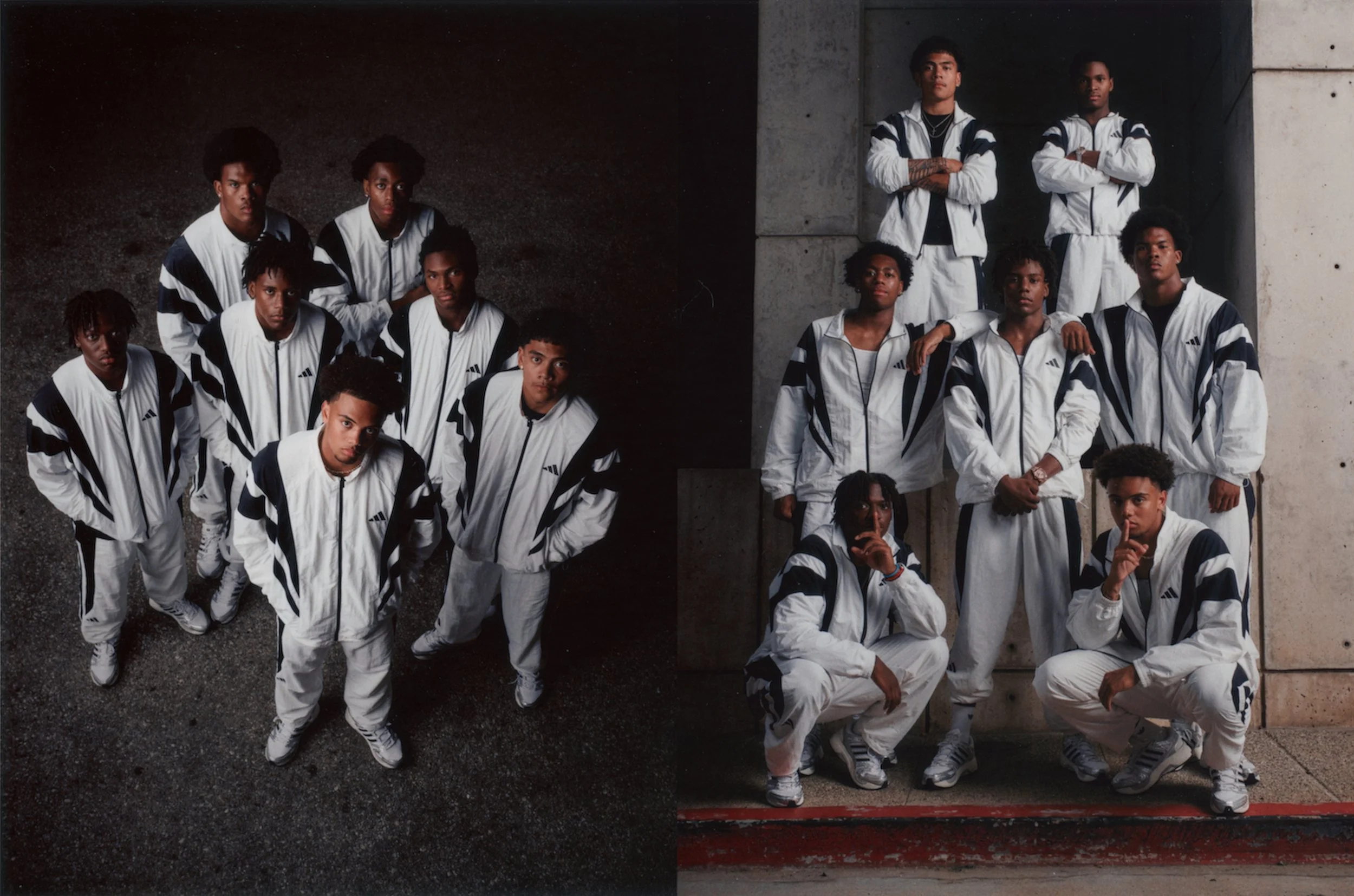 Group of young people wearing matching white and black tracksuits, posing in front of a concrete wall, with some standing and others sitting or kneeling.