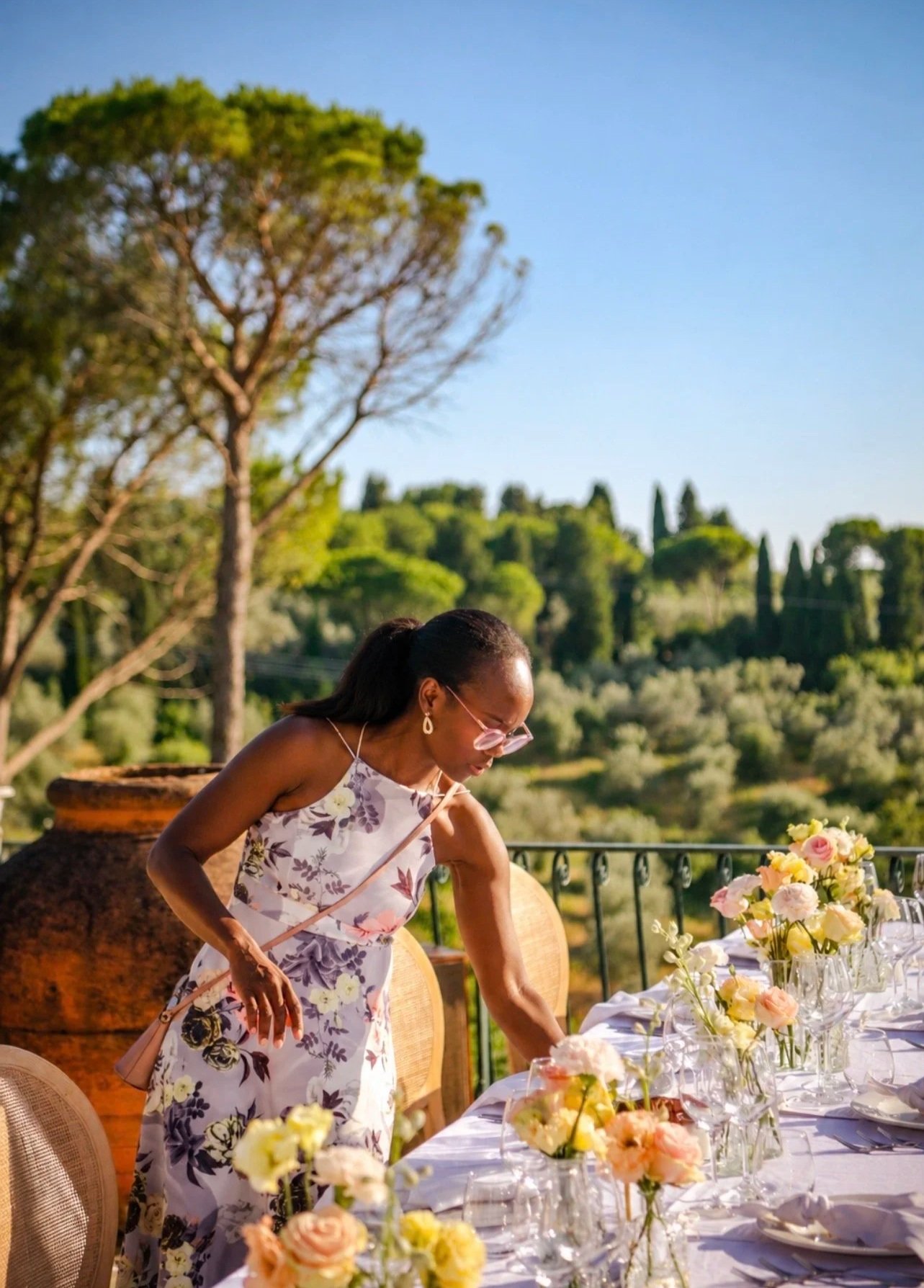 Wedding floral design being arranged on an outdoor dining table in Impruneta Florence. The lady in the picture is Shakeira Prince Wedding and event planner in Italy