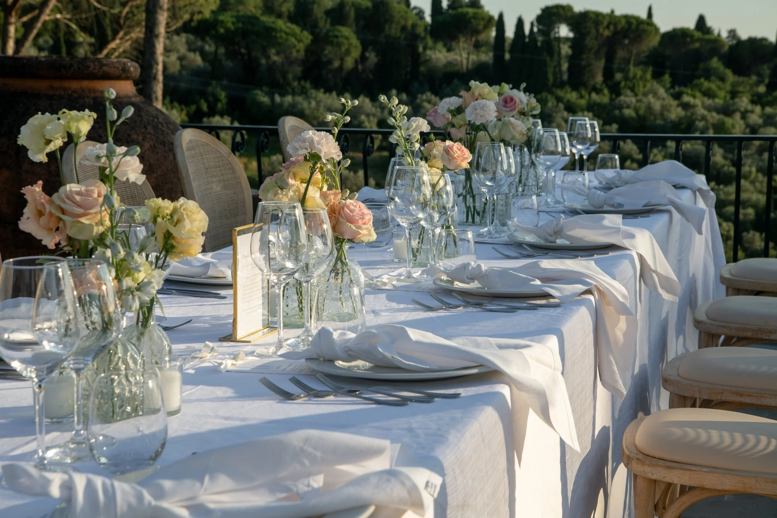 Long outdoor wedding reception table overlooking the Tuscan landscape