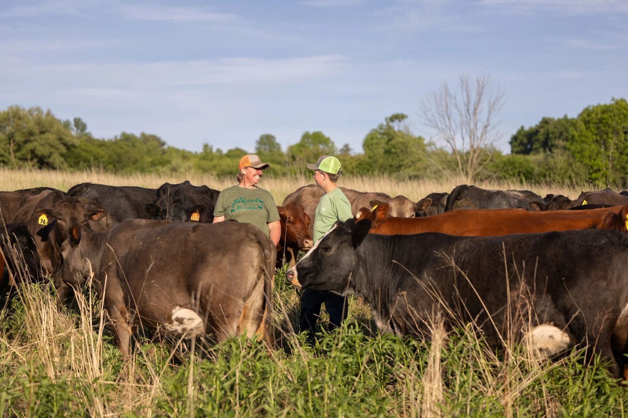 Angela and Elam at @bedientfarms with some of their beloved cows on their 200+ acres of pasture.