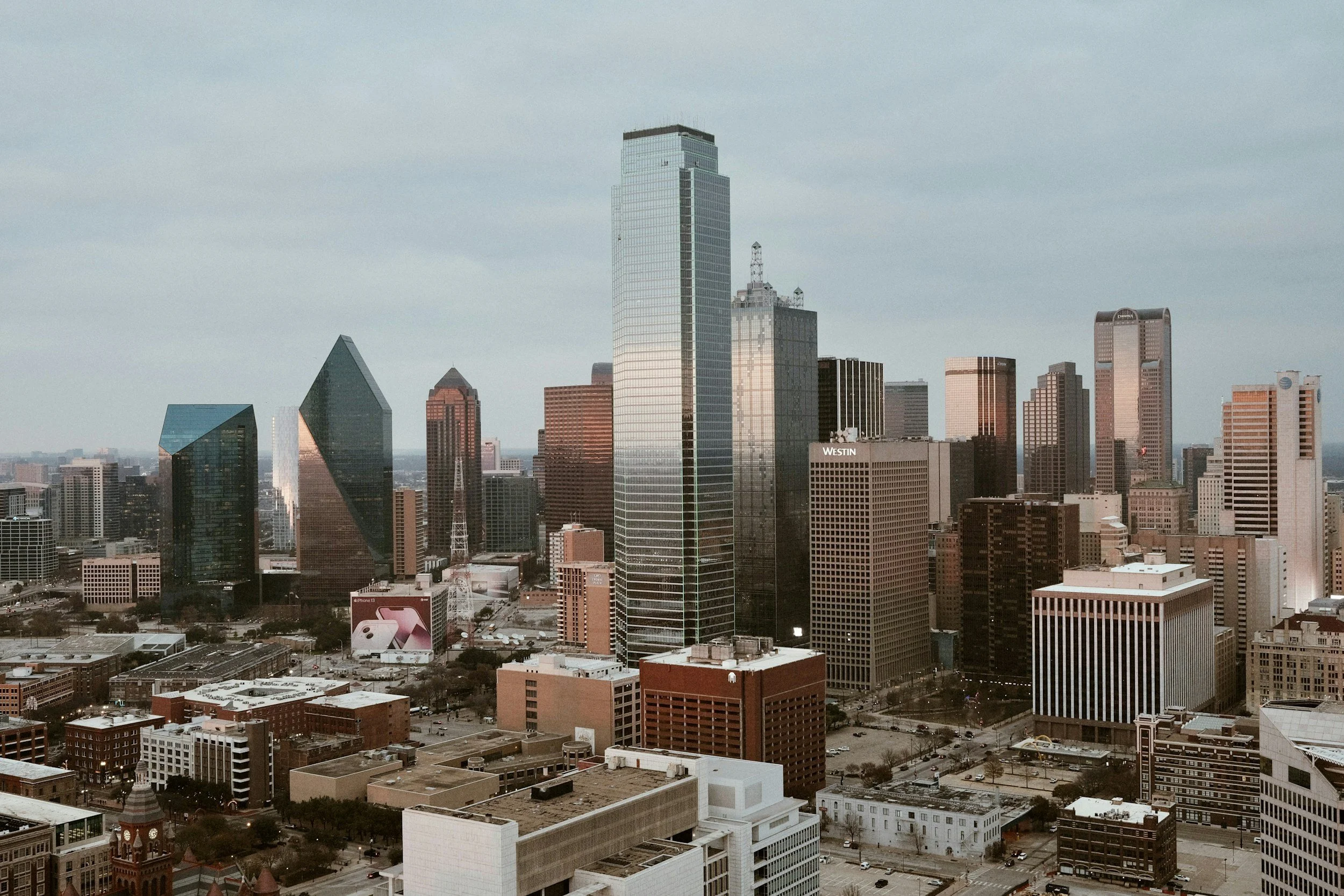 Skyline of downtown Dallas, Texas with tall skyscrapers and a mix of modern and historic buildings in a cityscape view during daytime.