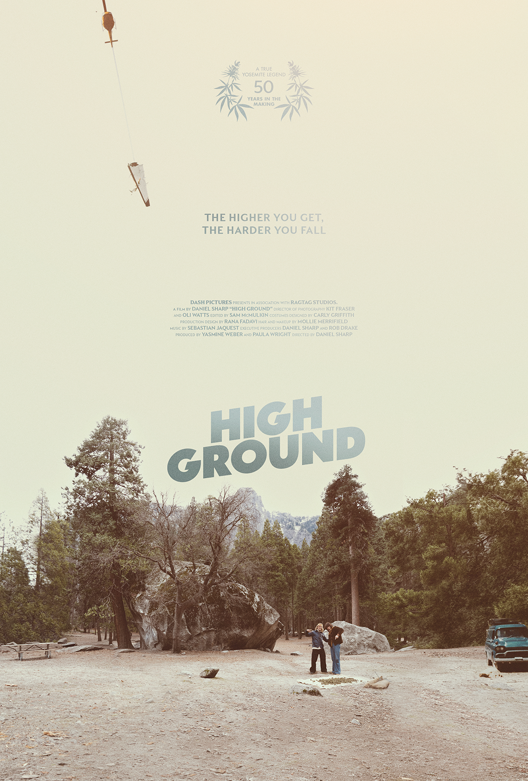A poster for the documentary film 'High Ground'. It shows a natural landscape with trees and large rocks, with two people standing and talking near the center, and a vehicle parked to the right. The background has a light, muted color and a helicopter is flying in the top left corner. The text highlights the film's 50th anniversary and features quote and production details.