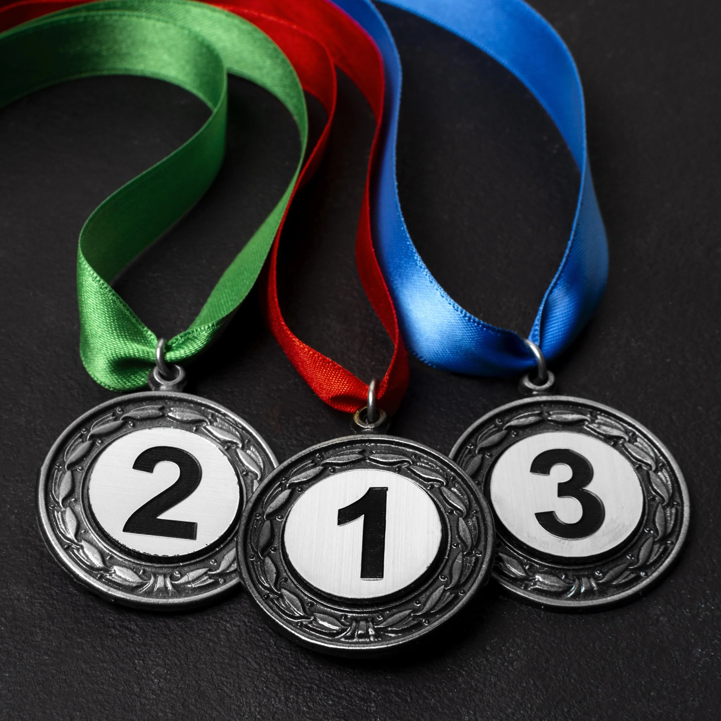 First, second and third place medals awarded at a Run Collective UK corporate running event
