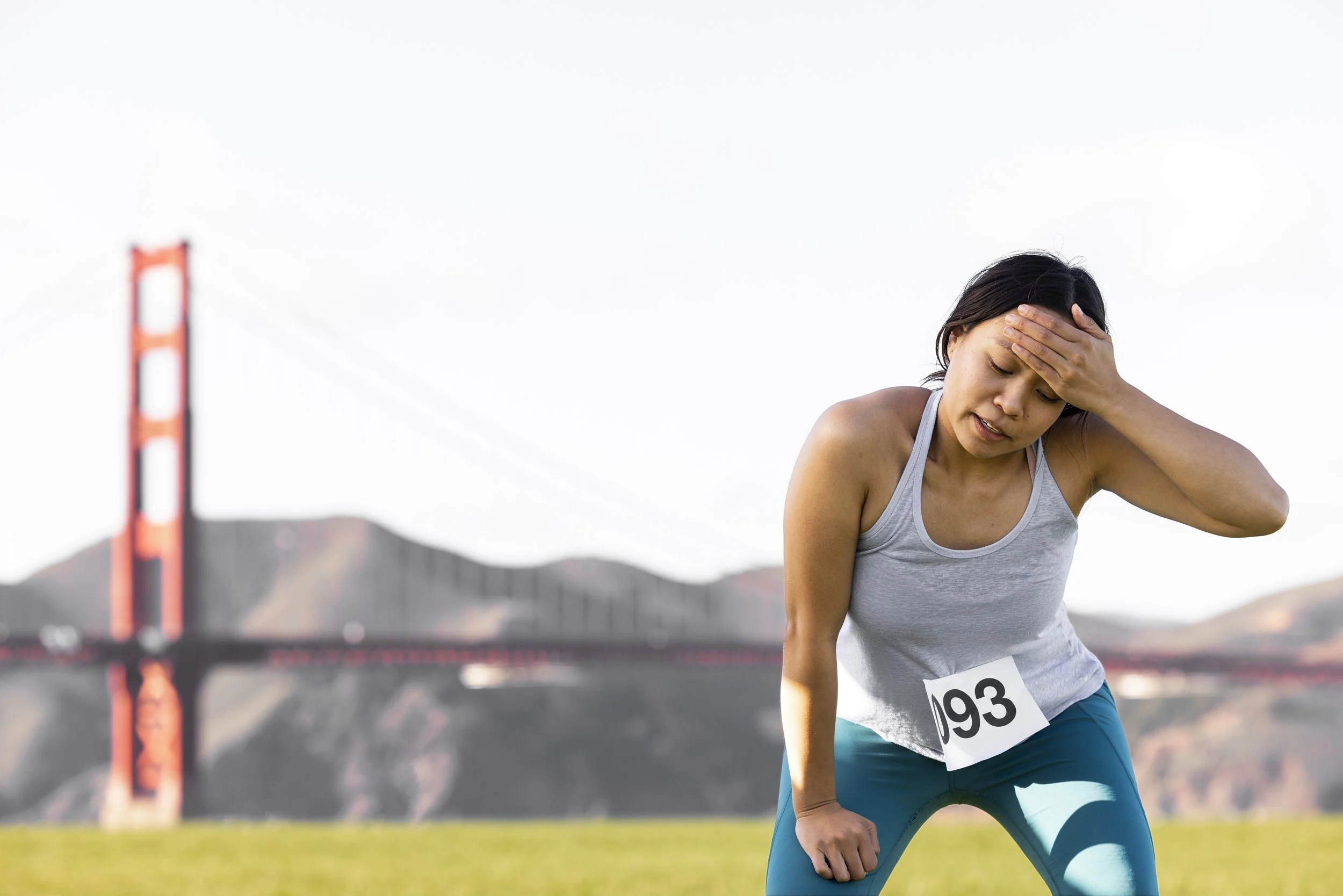 Tired runner catching her breath after a Run Collective corporate running event.