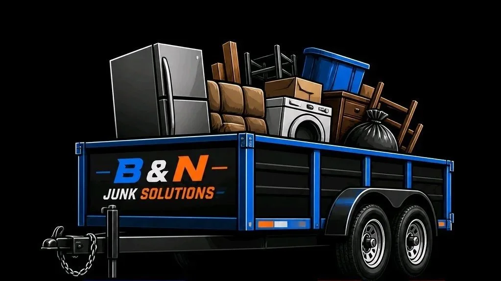 A trailer filled with assorted junk including appliances, furniture, boxes, and bags, with a sign on the side reading 'B&N Junk Solutions' in blue, orange, and white letters.