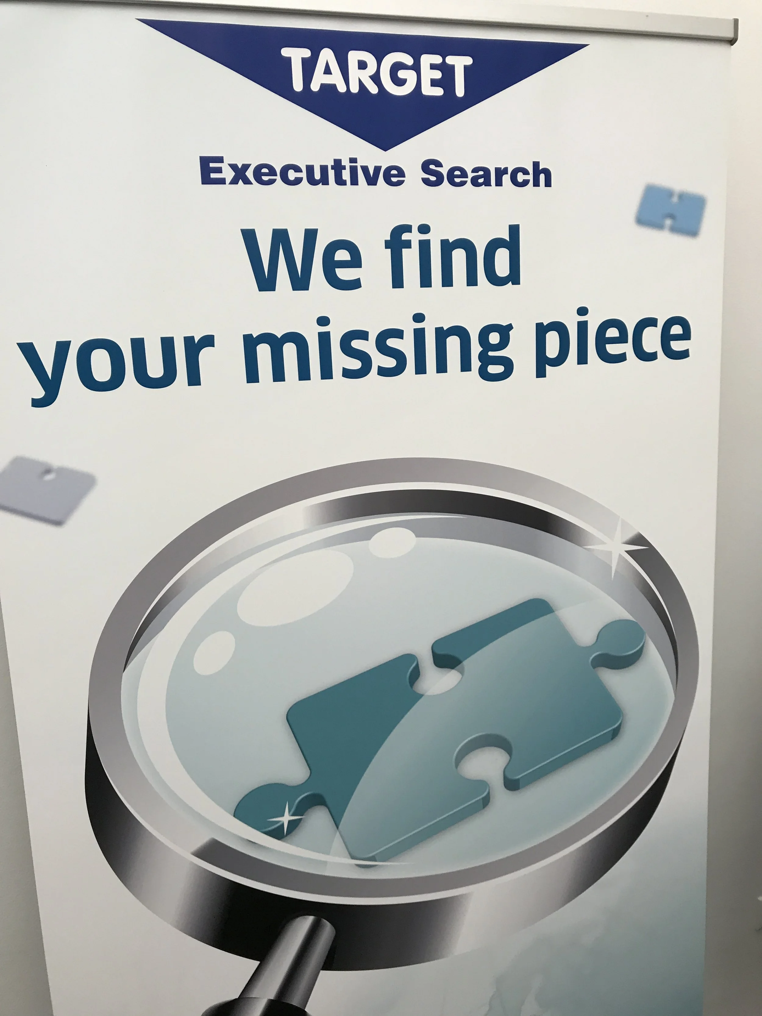Sign for Target with a message about finding missing pieces, featuring a target and a puzzle piece.