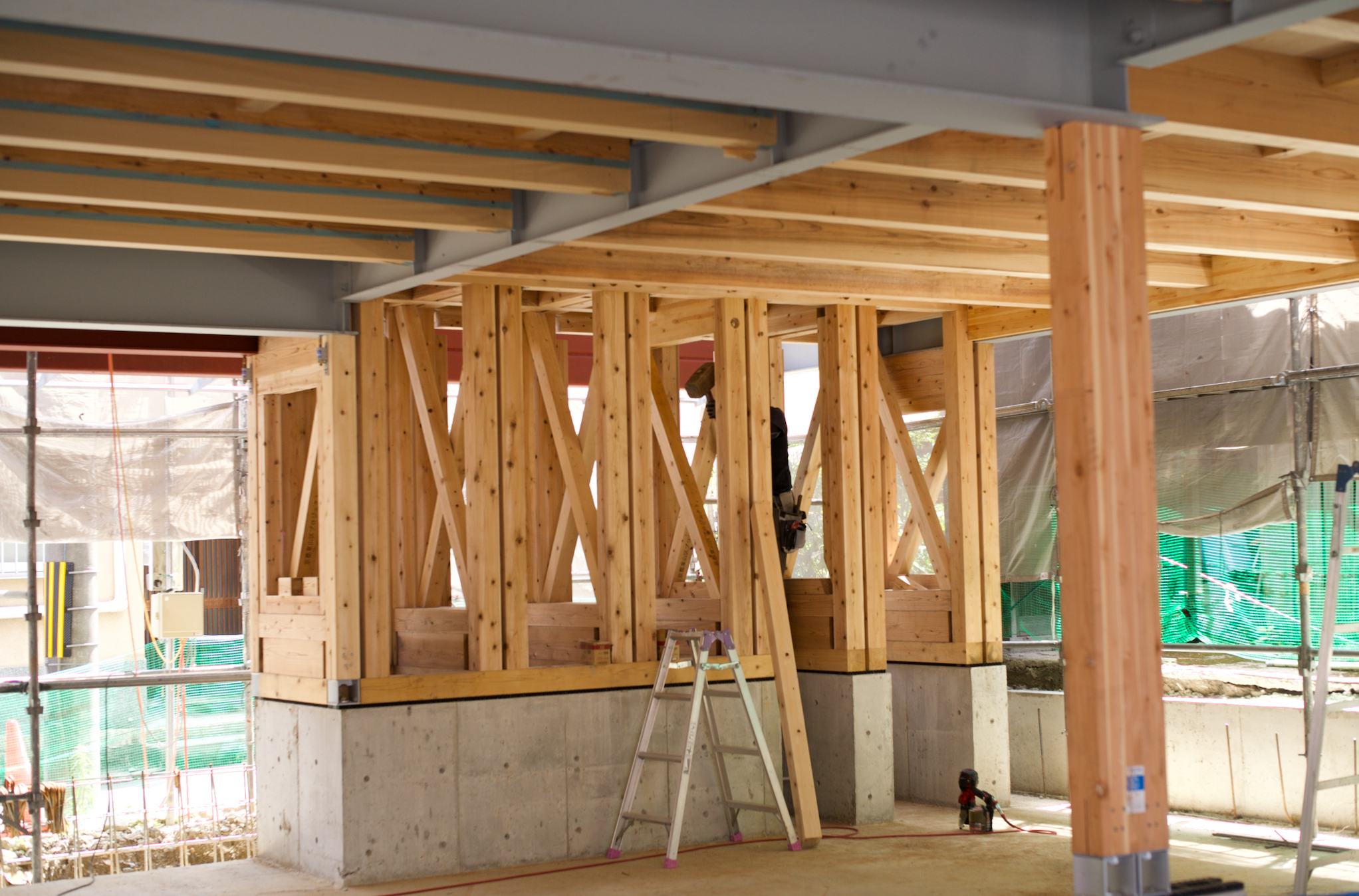 Construction site with wooden framing and structural supports for a building under construction.