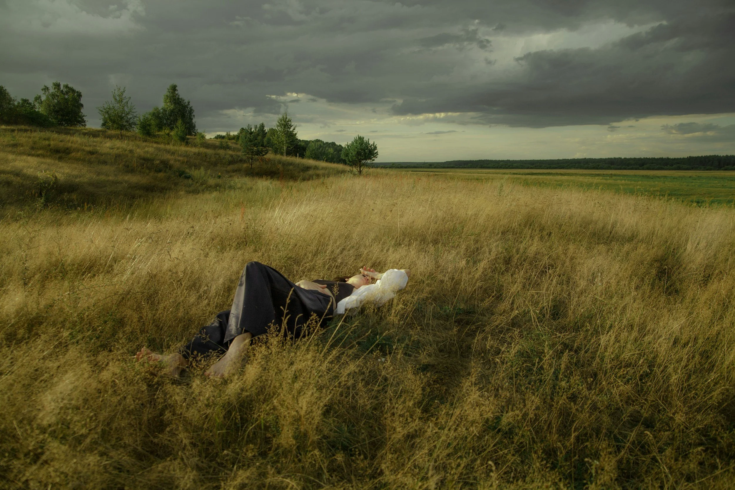 a person laying in a field calmly 