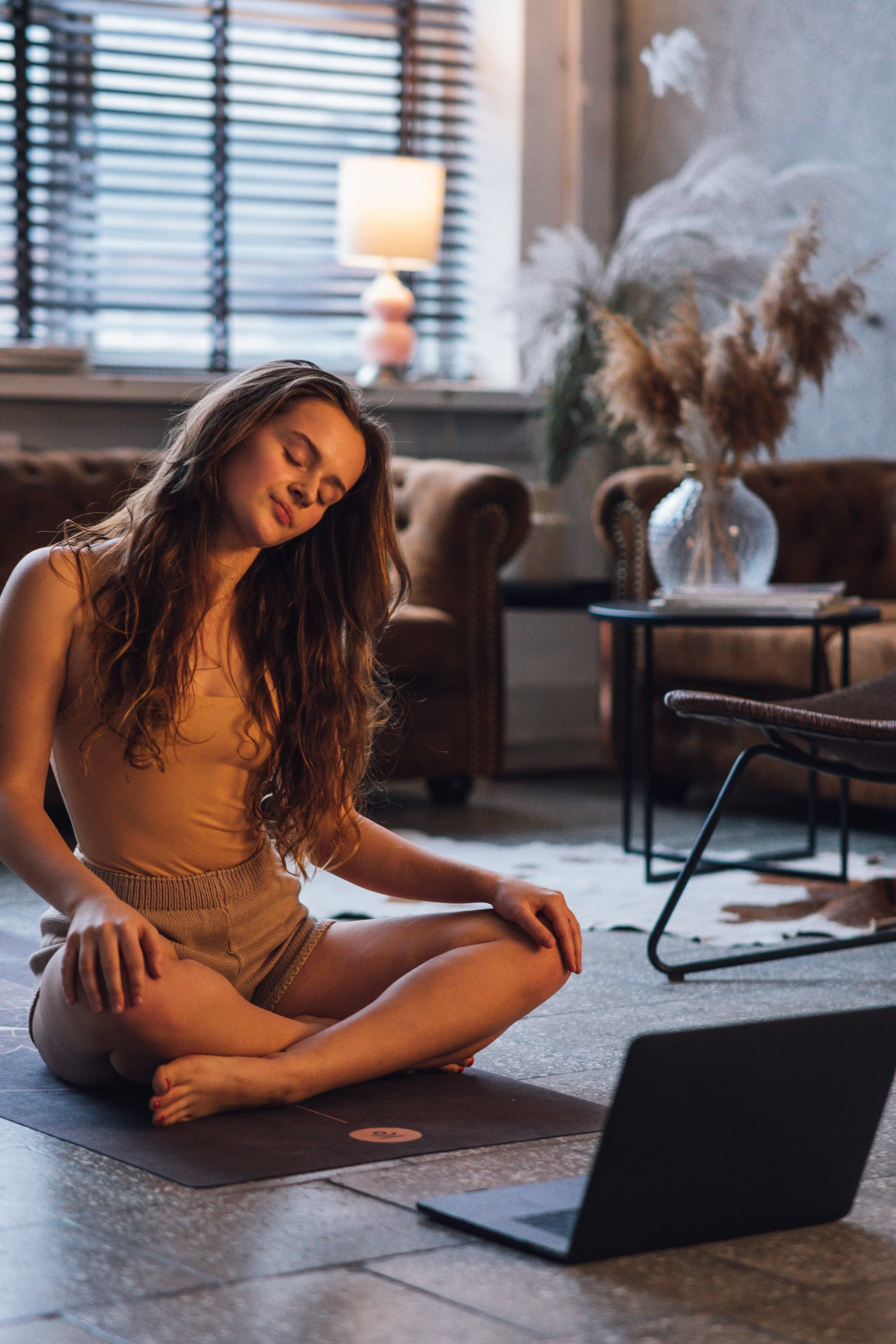 A woman in hypnosis during her online therapy session.