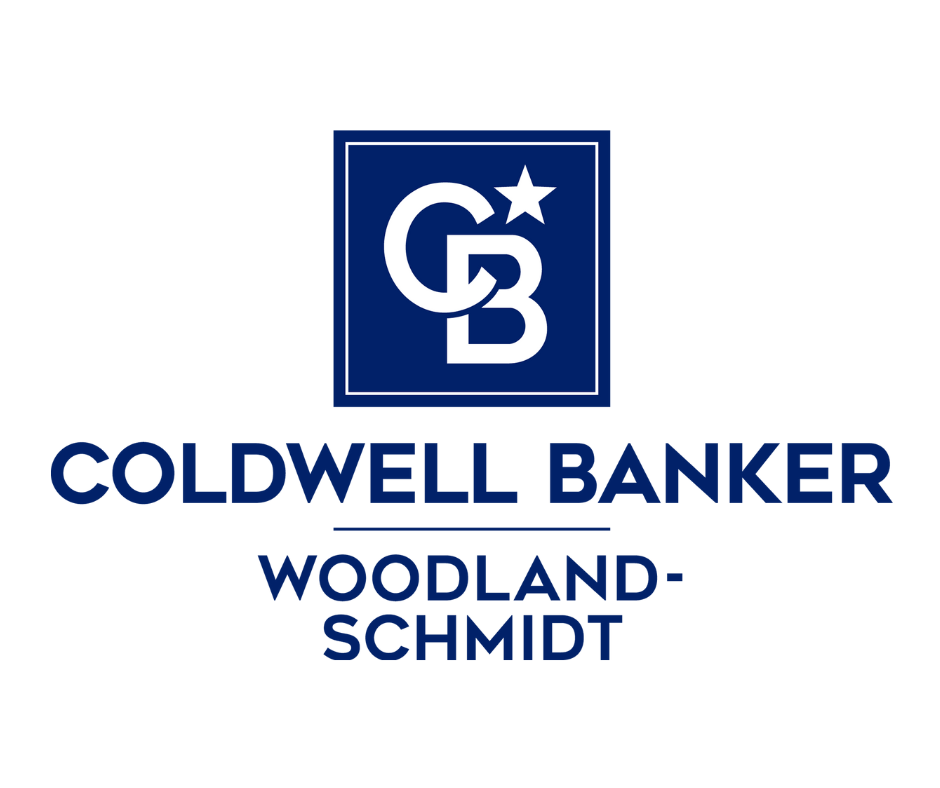 Coldwell Banker Woodland-Schmidt logo with blue text and graphic on a white background.