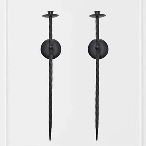Two black garden lights with pointed stakes and round tops against a gray background.
