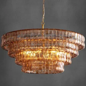 Vintage glass chandelier with a tiered, scalloped design hanging from a chain.