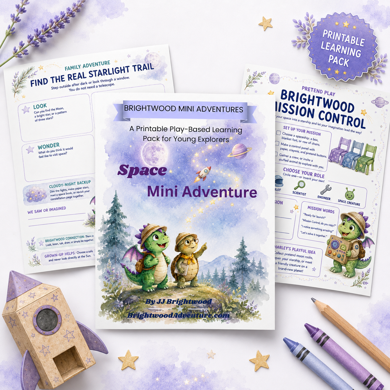 Brightwood Mini Adventures space-themed printable children's learning pack with illustrations of cartoon dragons, trees, starry sky, and a rocket, surrounded by purple crayons, a star-shaped pencil holder, and star-shaped decorations.