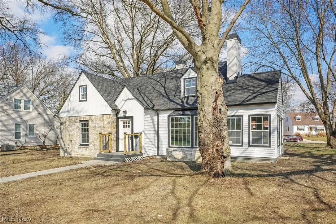 Parma, Ohio: close-up of the renovated front exterior showing the dormer, updated windows and front entry.