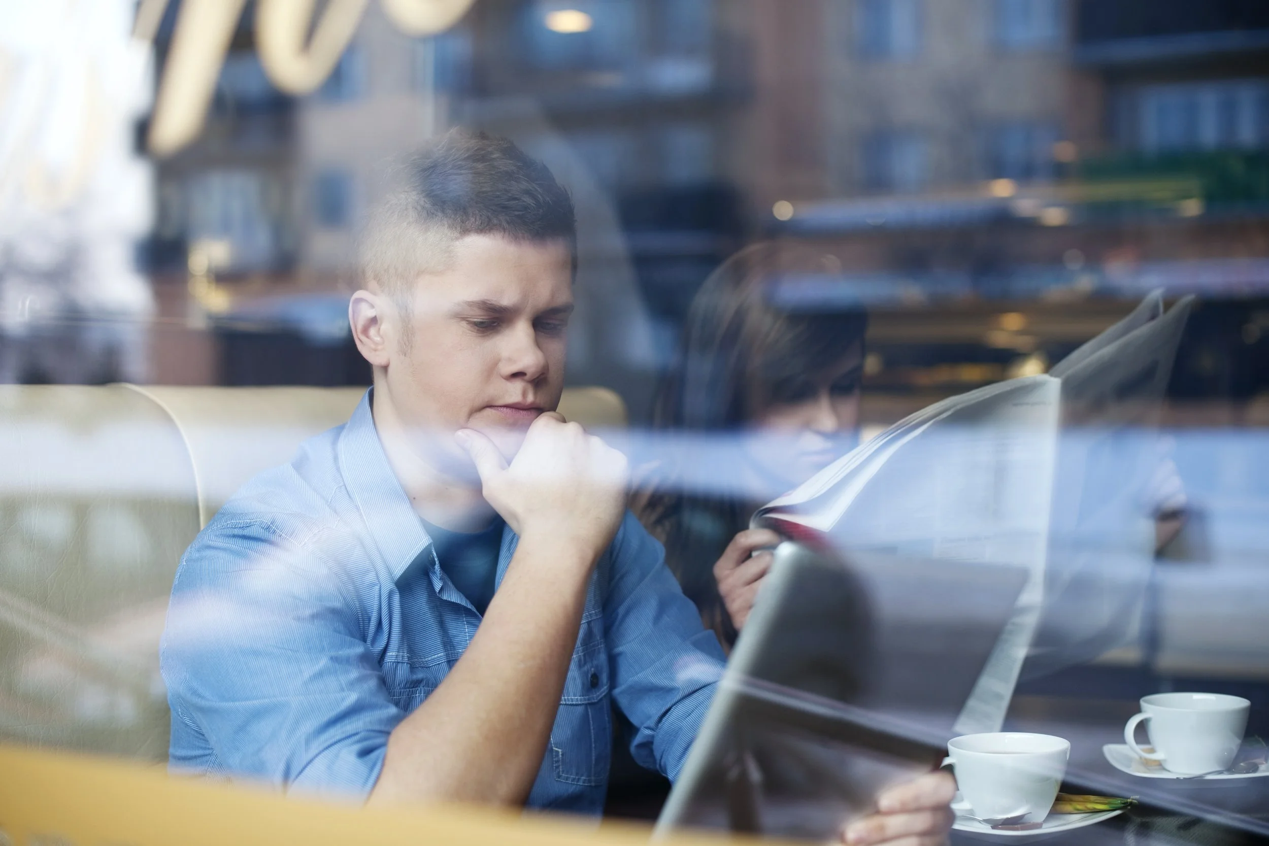 A student working on a laptop in a café.