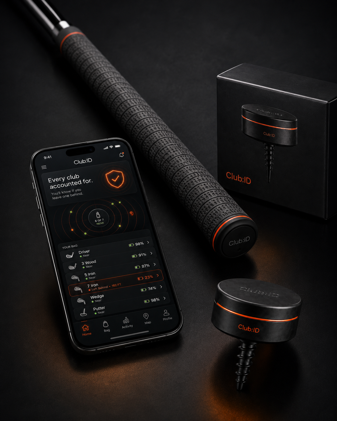 A golf app and GPS device for tracking golf club usage and distances, displayed on a smartphone, with a golf tee and box for a GPS golf tracker on a dark surface.