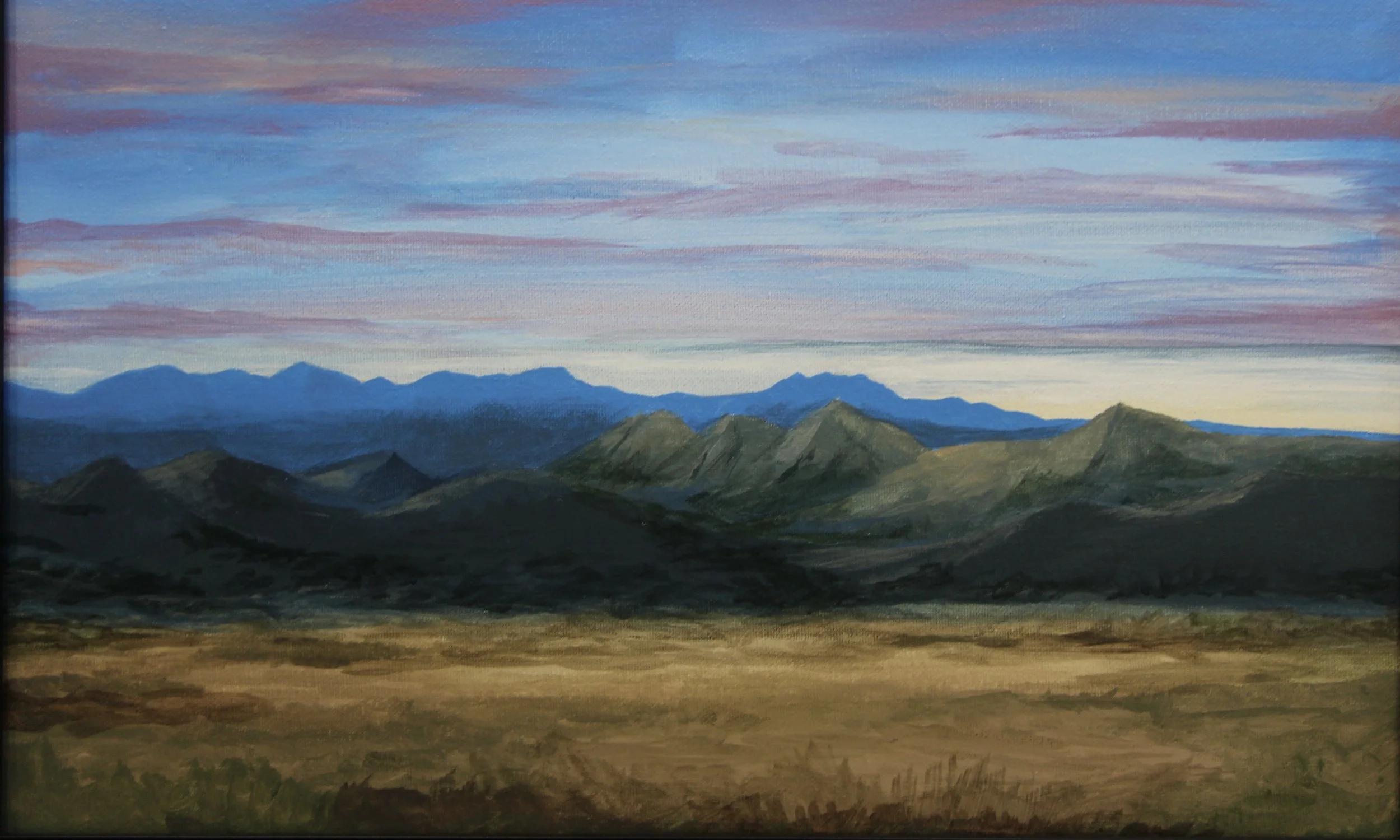 A landscape painting of mountains under a colorful sky at sunset or sunrise.