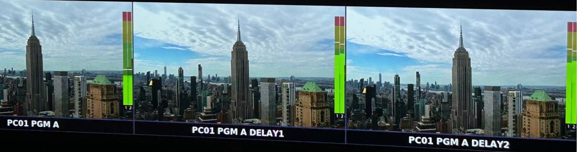 Side-by-side comparison of a daytime city skyline with the Empire State Building, showing three different video feeds labeled PC01 PGM A, PC01 PGM A DELAY1, and PC01 PGM A DELAY2, with a color-coded signal strength indicator.