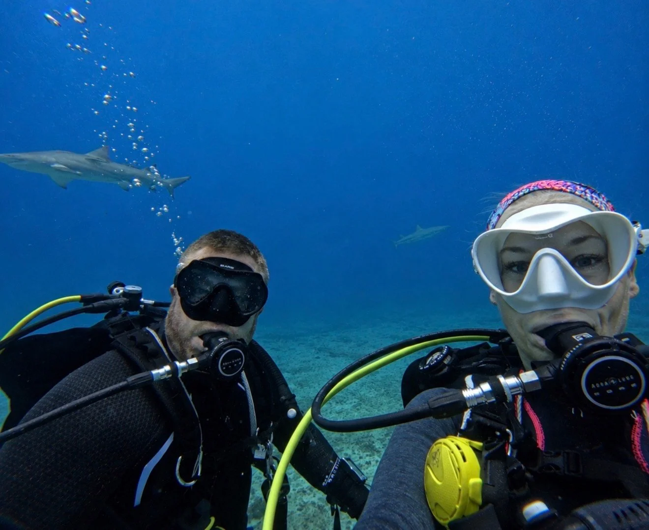 Scuba instructors Landis and Jessica Rains diving together underwater