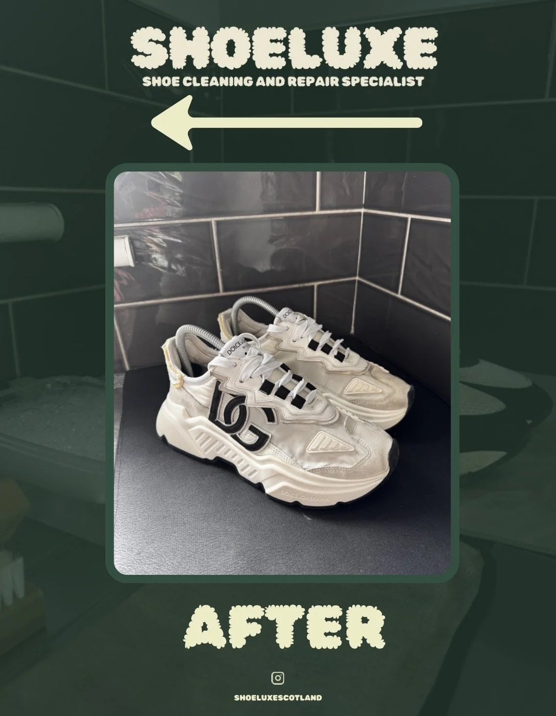 A pair of white sneakers with black details on a black surface, with a dark tiled wall in the background.
