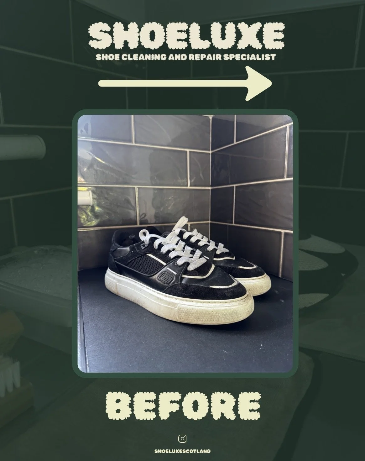Pair of black vintage sneakers with white soles and black laces on a black surface in front of a gray tiled wall.