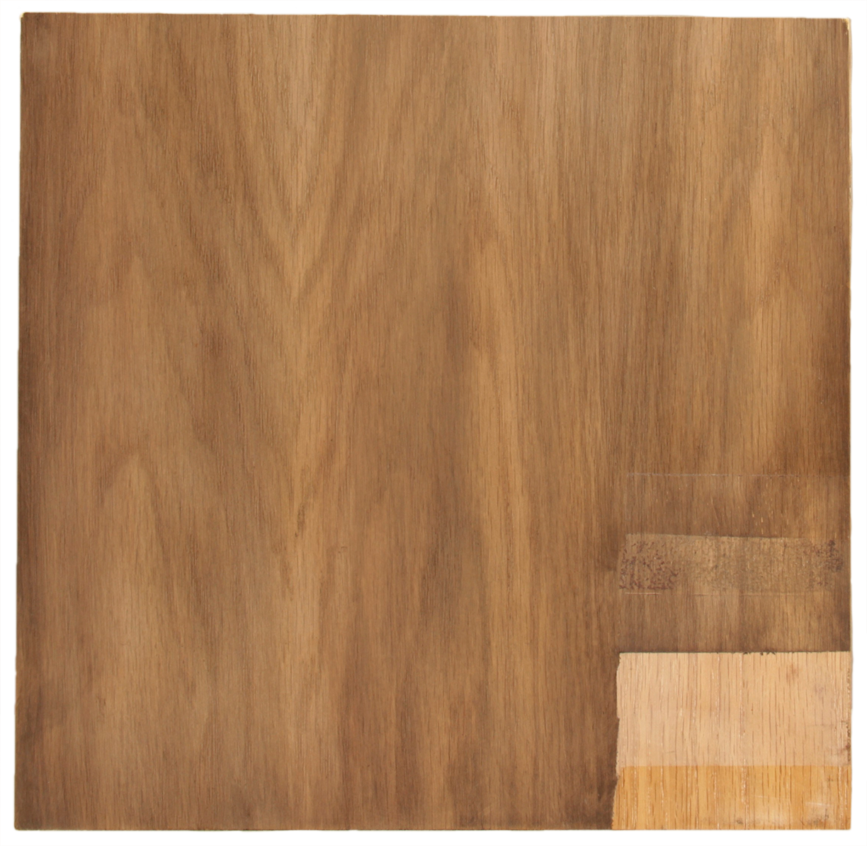 Close-up of a large rectangular wood-grain panel with lighter exposed wood sections along the lower-right edge