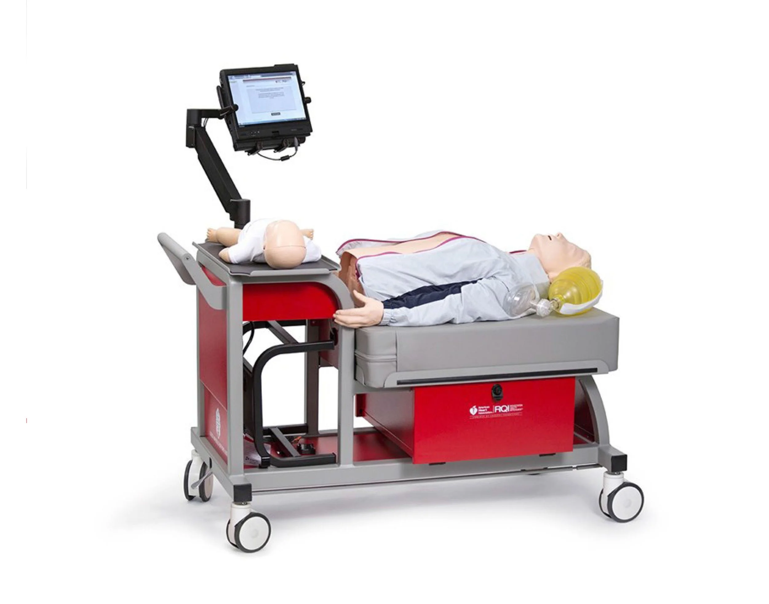Medical training mannequin lying on a wheeled emergency stretcher beside a mounted patient-monitor display