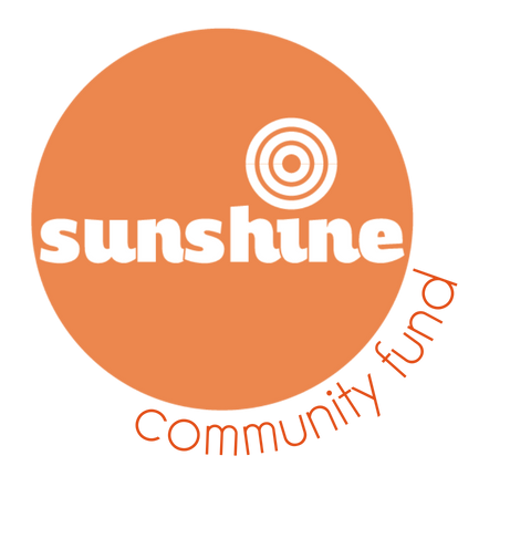 Logo for Sunshine Community Fund featuring an orange circle with a white target symbol above the word 'sunshine' and 'community fund' in orange circular text.