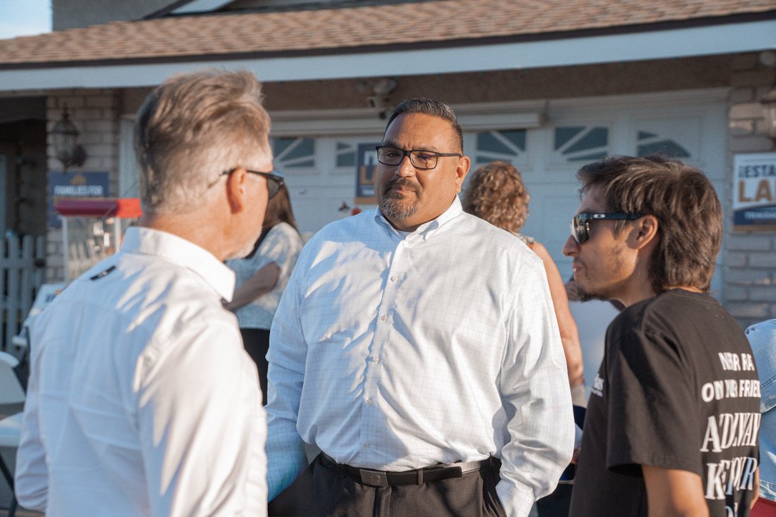 Larry Trinidad listening to two District 3 residents at a neighborhood meet and greet