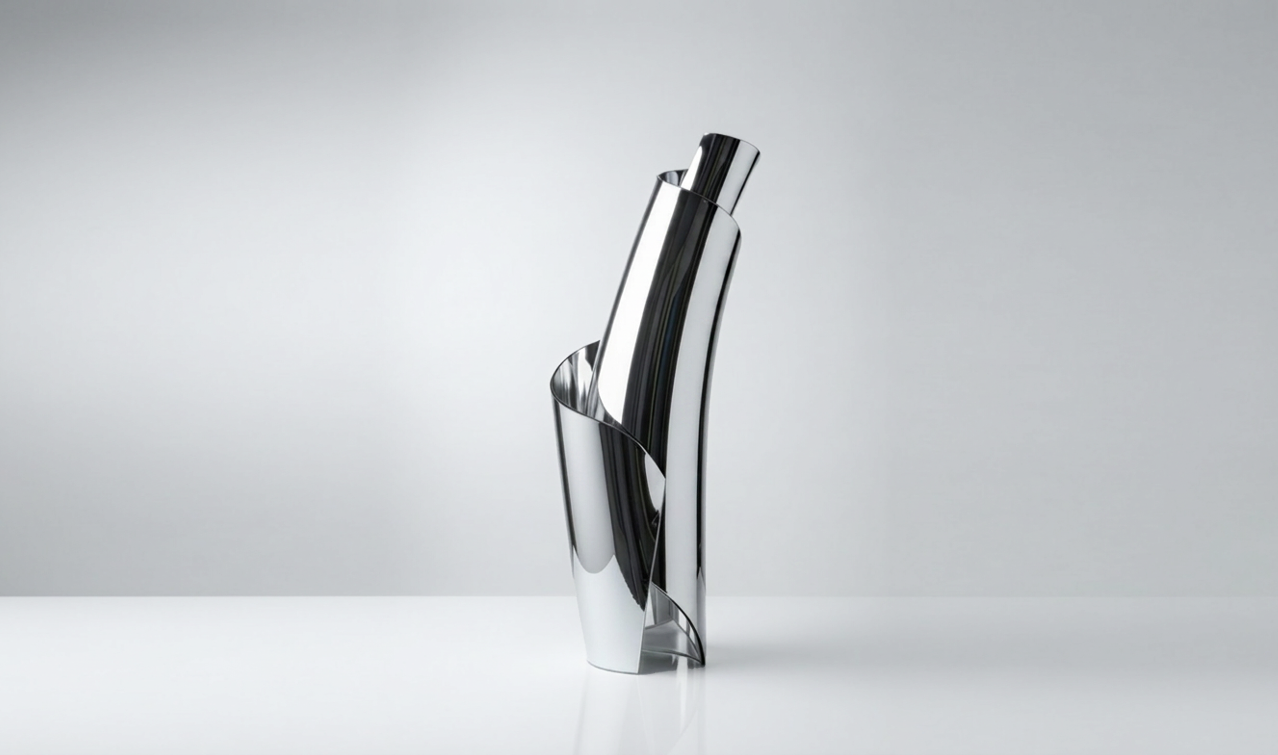 Spiral Vase by Pheiffer — a mirror-polished chrome vessel formed from a single twisting sheet.