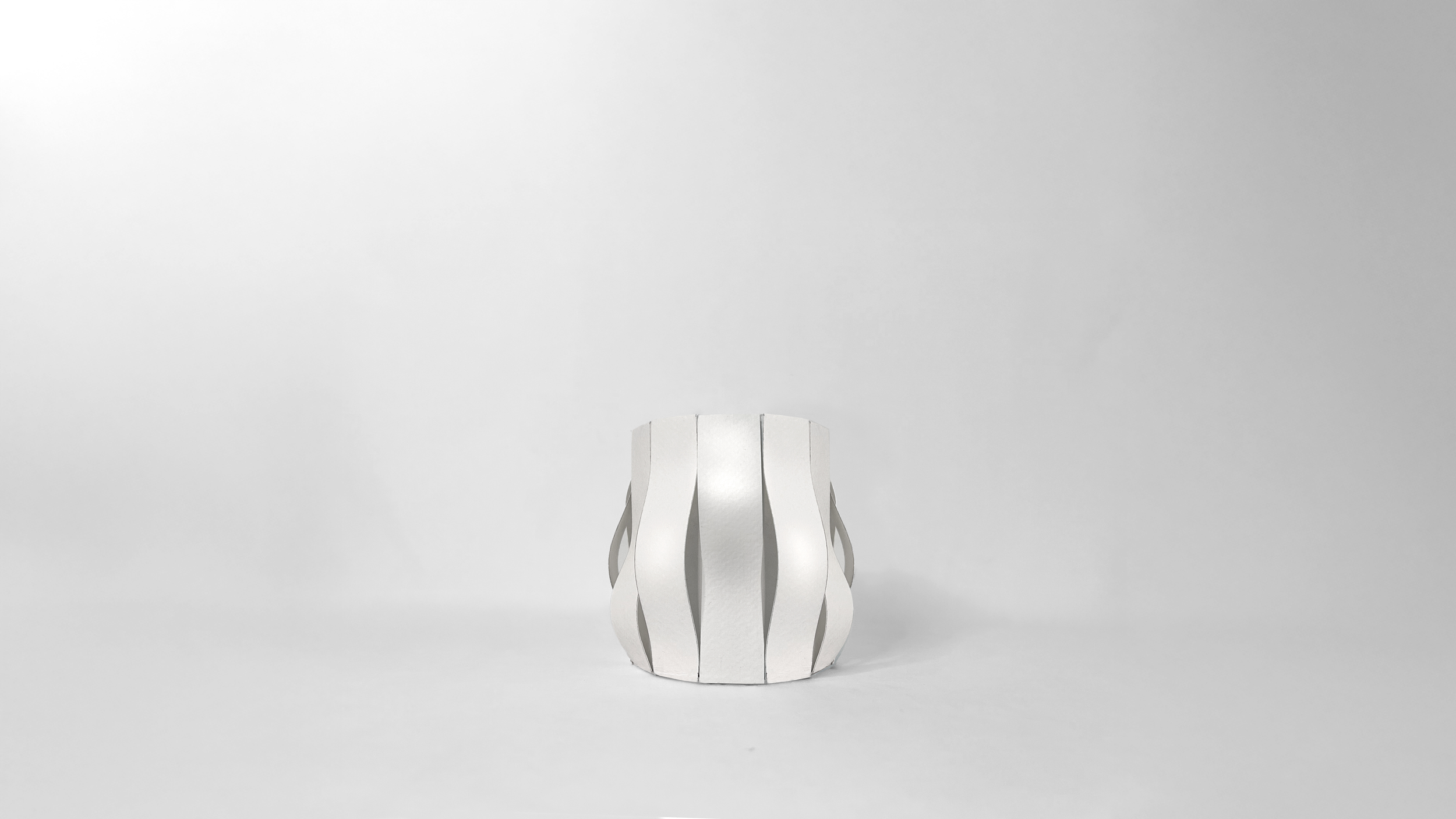 Paper study model of the Finger Wave Mug by Pheiffer — hand-cut card panels forming the rib and handle geometry before the ceramic version.