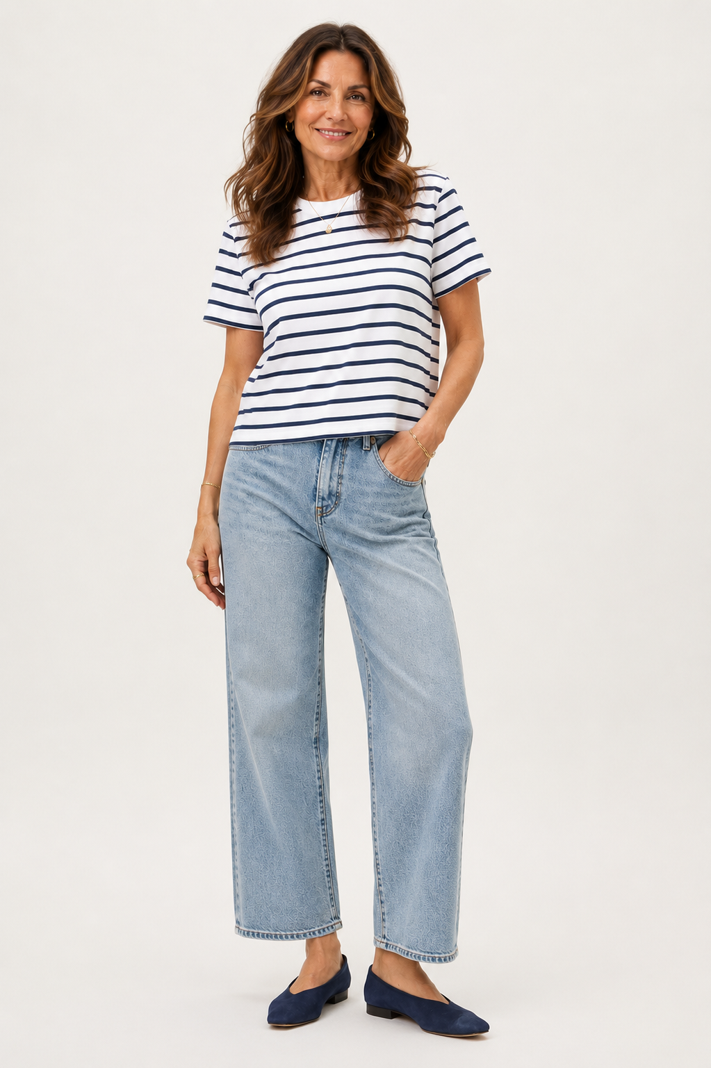 Woman in her 50s wearing wide leg jeans and tee.