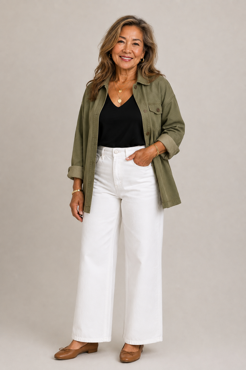 Woman in her 60s wearing wide leg jeans with a tank and jacket.